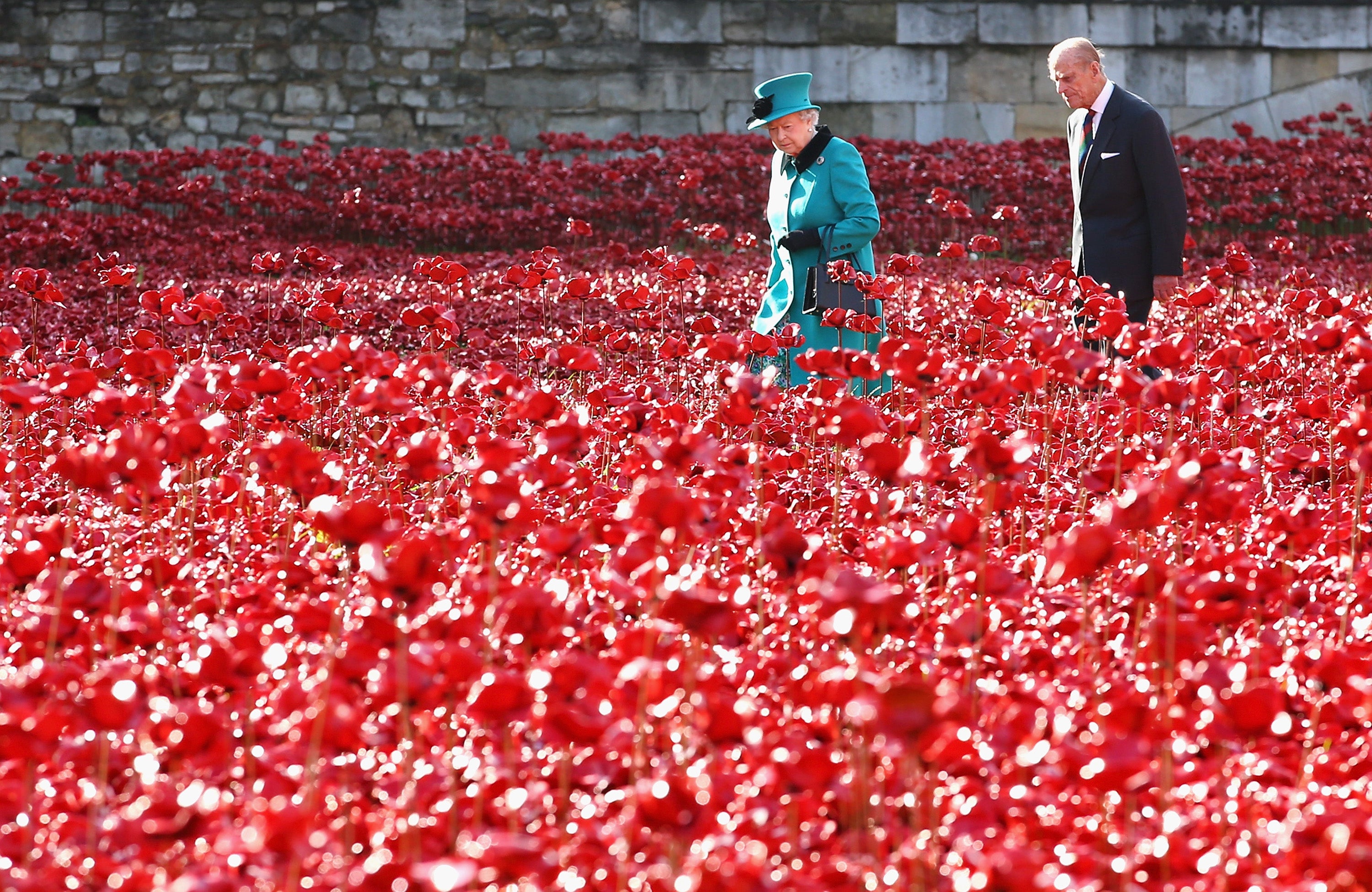 Queen Elizabeth II and Prince Philip, Duke of Edinburgh visit the Blood Swept Lands and Seas of Red evolving art installation at the Tower of London, 2014