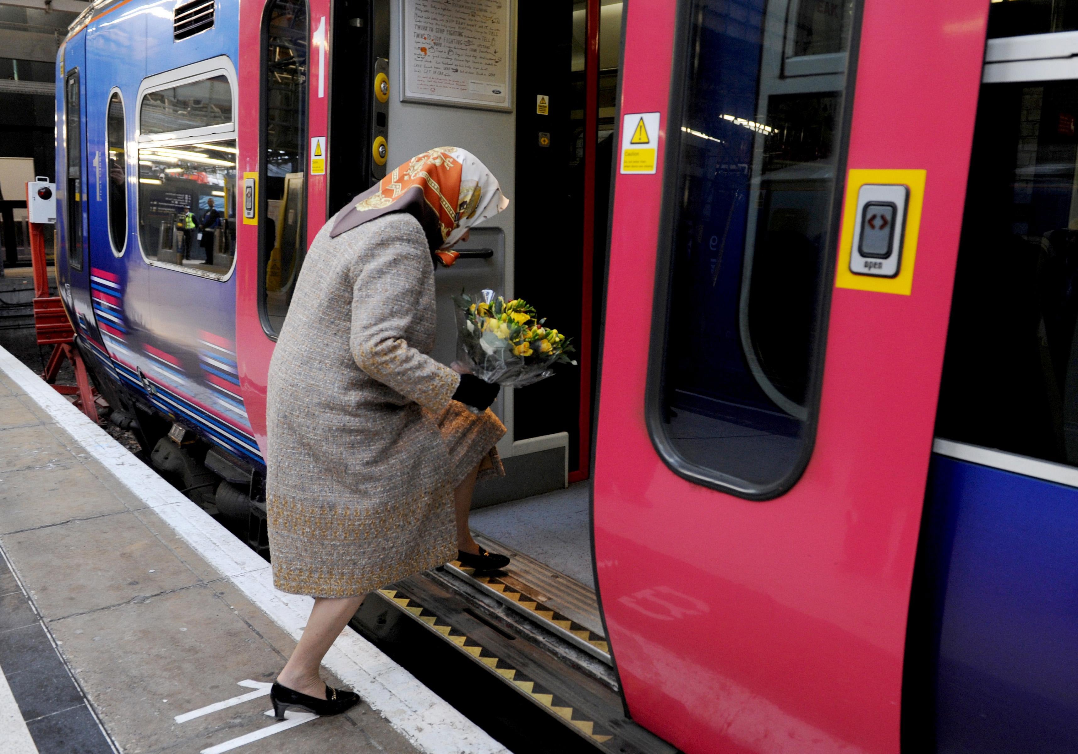 Queen Elizabeth boards a scheduled train at Kings Cross station in London, 2009