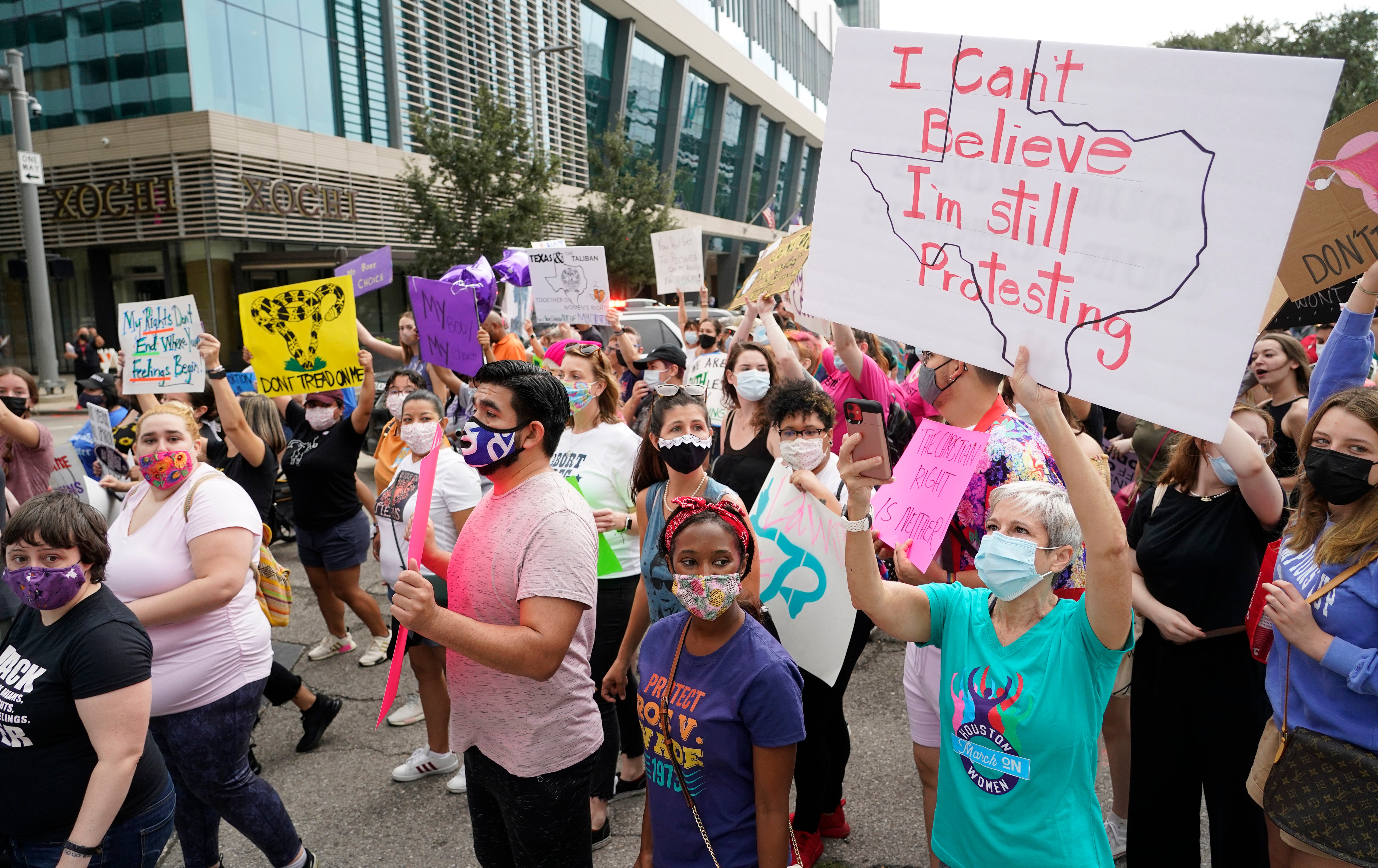 People participate in the Houston Women's March against Texas abortion ban walk from Discovery Green to City Hall in Houston.