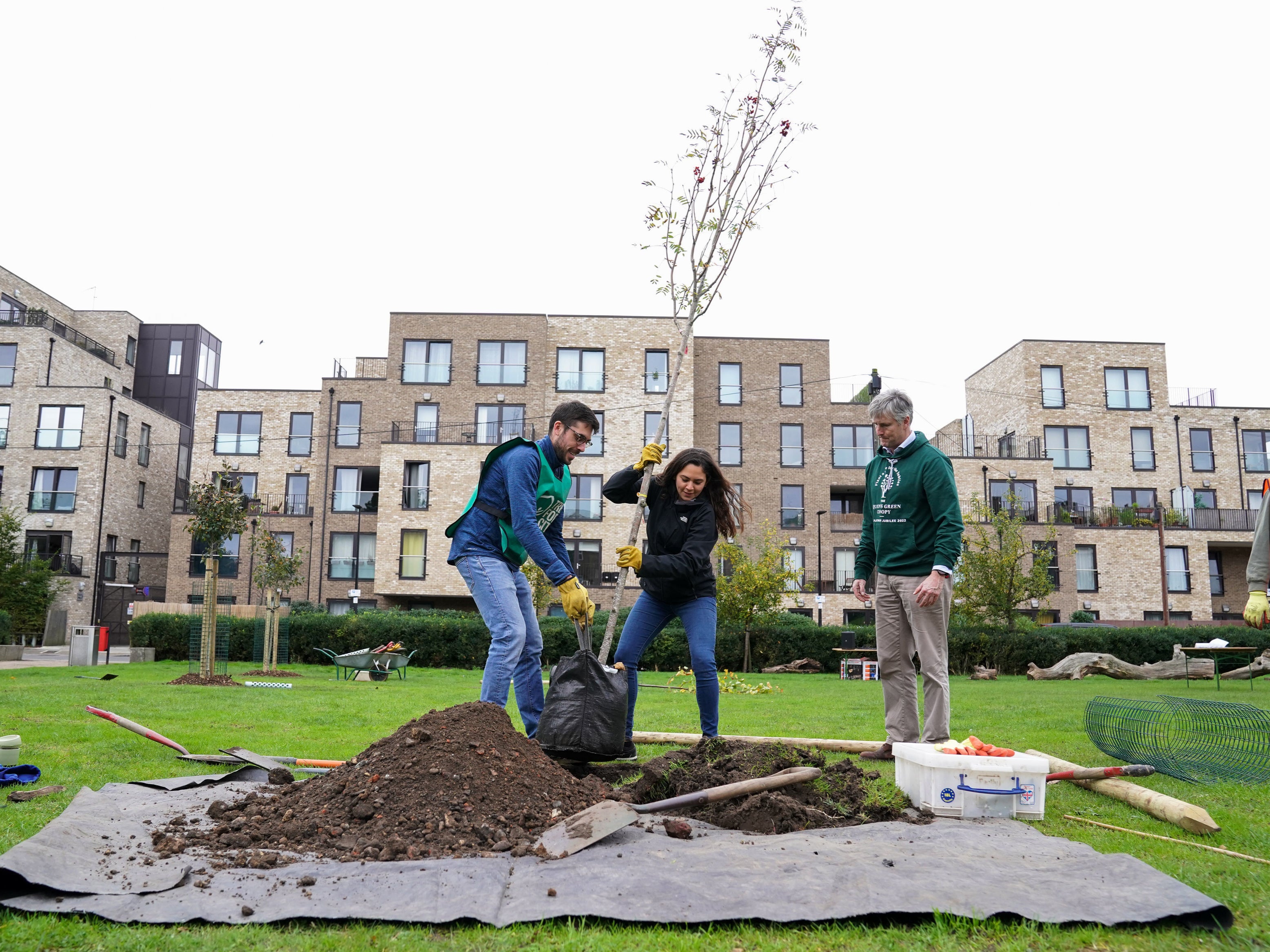 Volunteers help plant a tree at Furze Green in Tower Hamlets, east London, where the Queen's Green Canopy is unveiling its first urban greening project to mark to the Queen's Platinum Jubilee in 2022