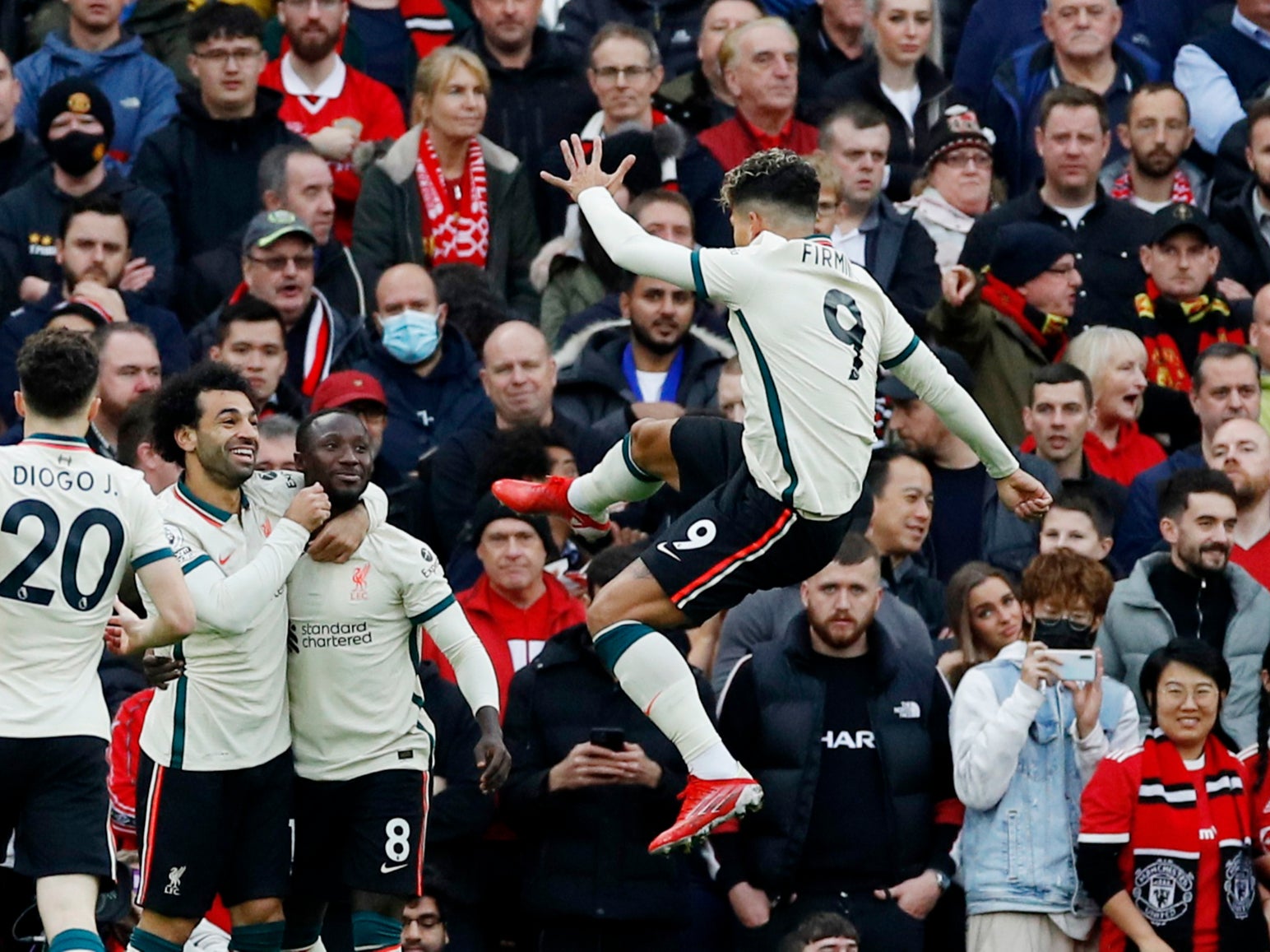 <p>Roberto Firmino celebrates with his Liverpool teammates</p>