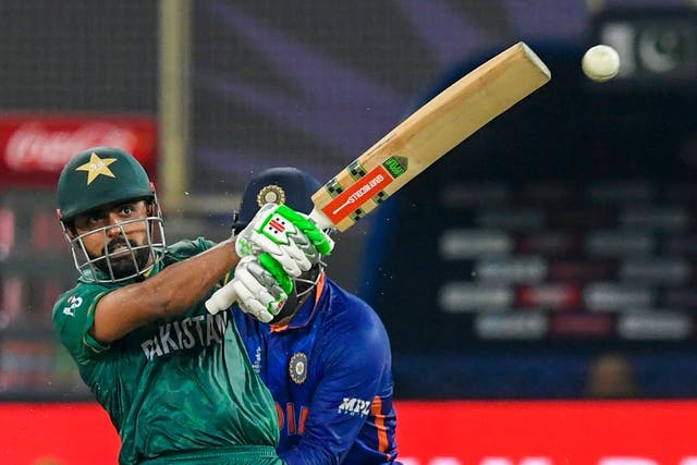<p>Pakistan’s captain Babar Azam plays a shot during the ICC mens Twenty20 World Cup cricket match between India and Pakistan on 24 October 2021 in Dubai </p>