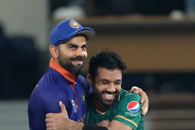 India captain Virat Kohli congratulates Pakistan batter Mohammad Rizwan (Aijaz Rahi/AP/PA)