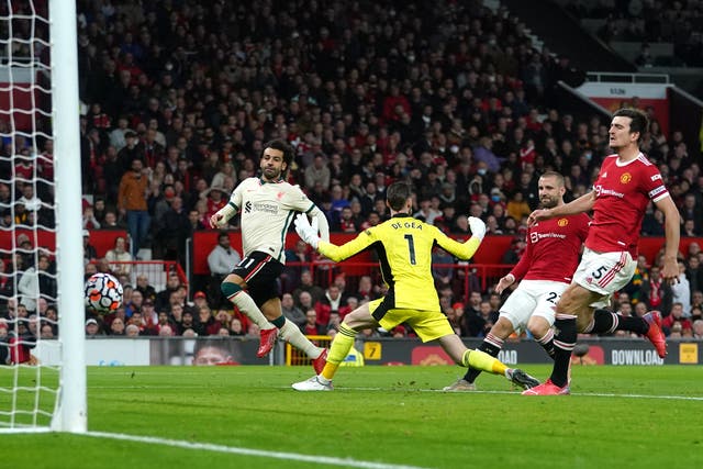 <p>Liverpool’s Mohamed Salah (left) completes his hat-trick in the 5-0 win over Manchester United at Old Trafford (Martin Rickett/PA)</p>