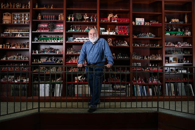 <p>Jorge Flores in front of a portion of his miniature collection at his home in Potomac</p>