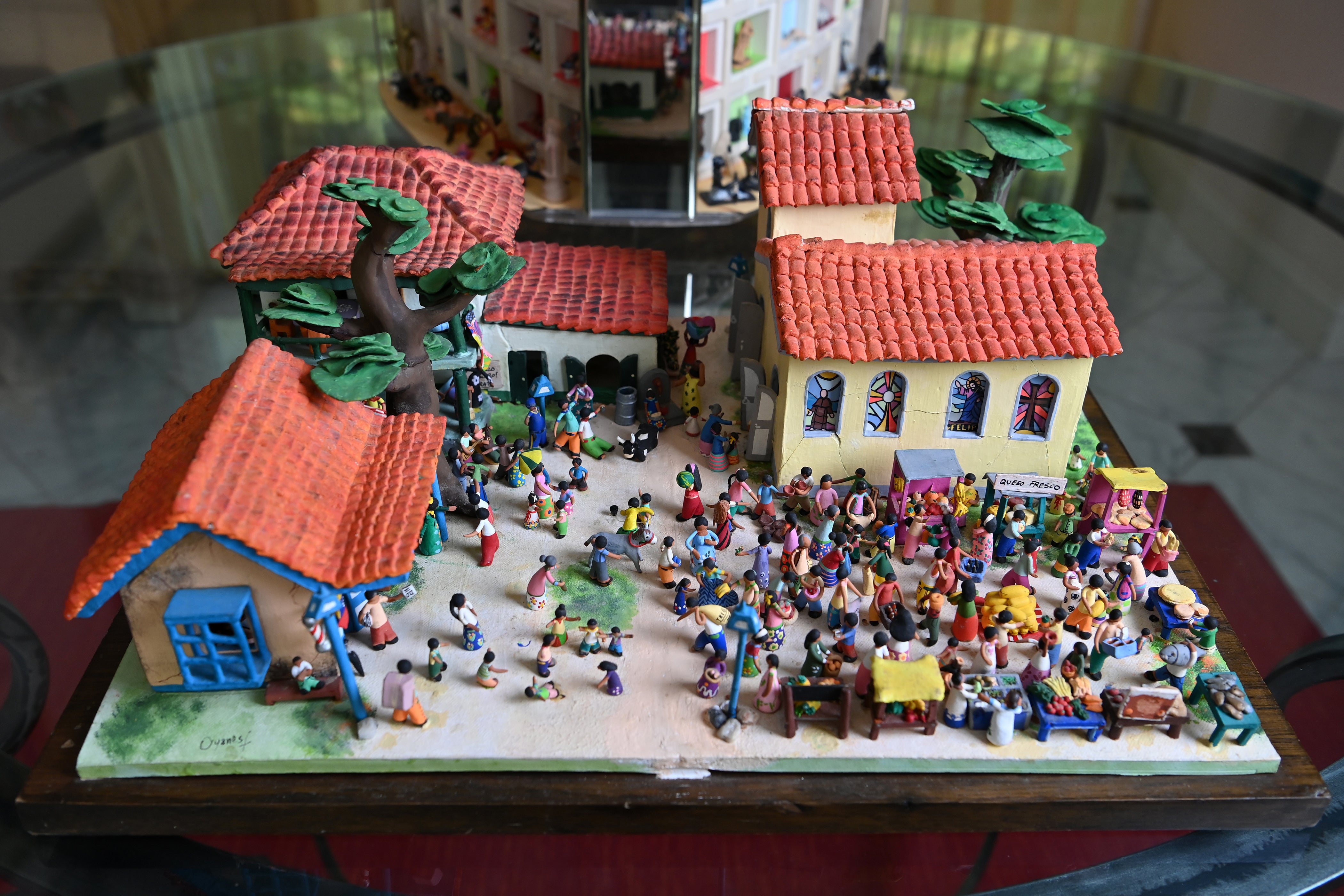 A miniature tableau depicts a town scene in Venezuela