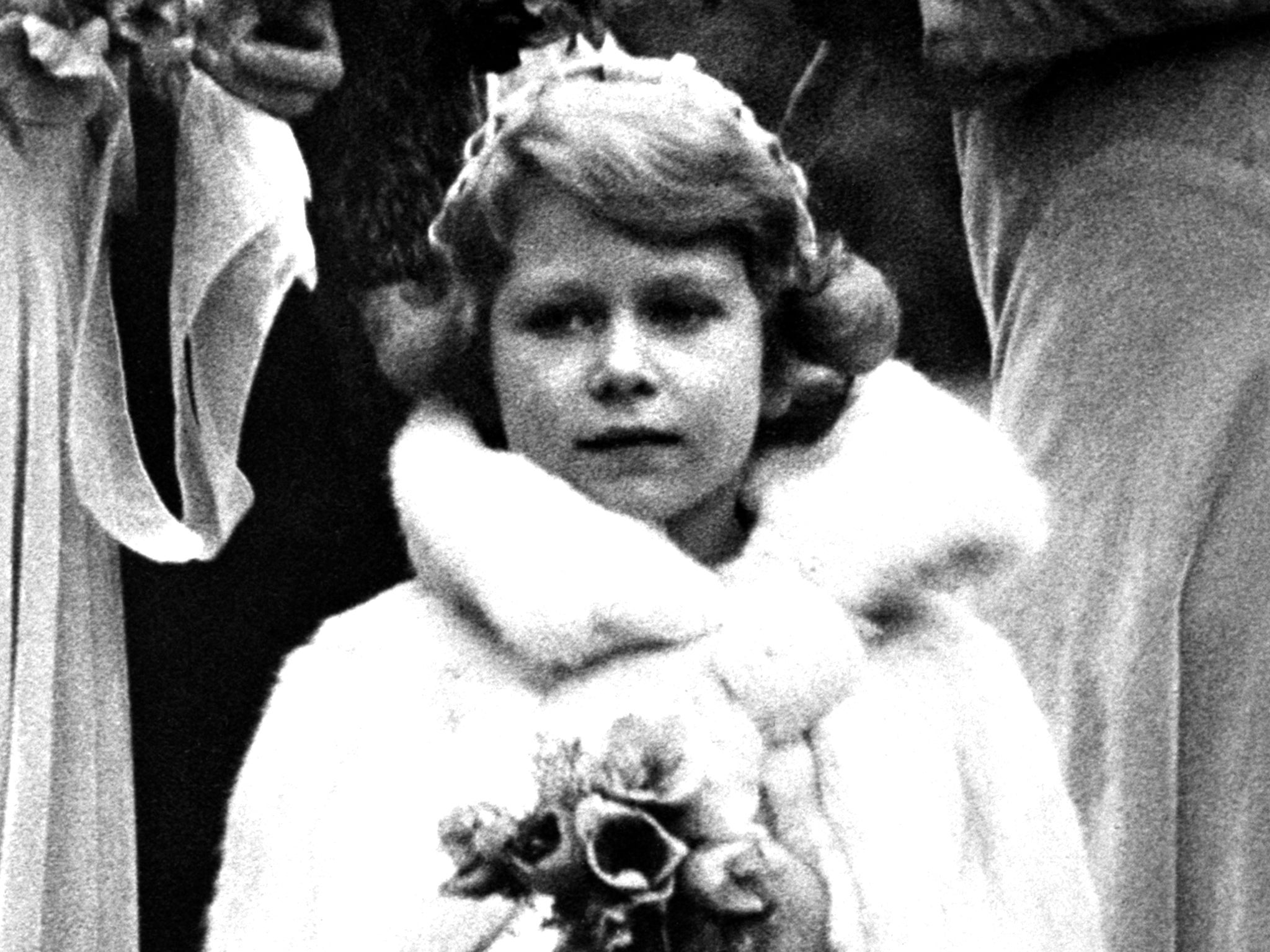 <p>1931: A five-year-old Prince Elizabeth attends the wedding of Lady May Cambridge, great-granddaughter of Queen Victoria in Sussex</p>