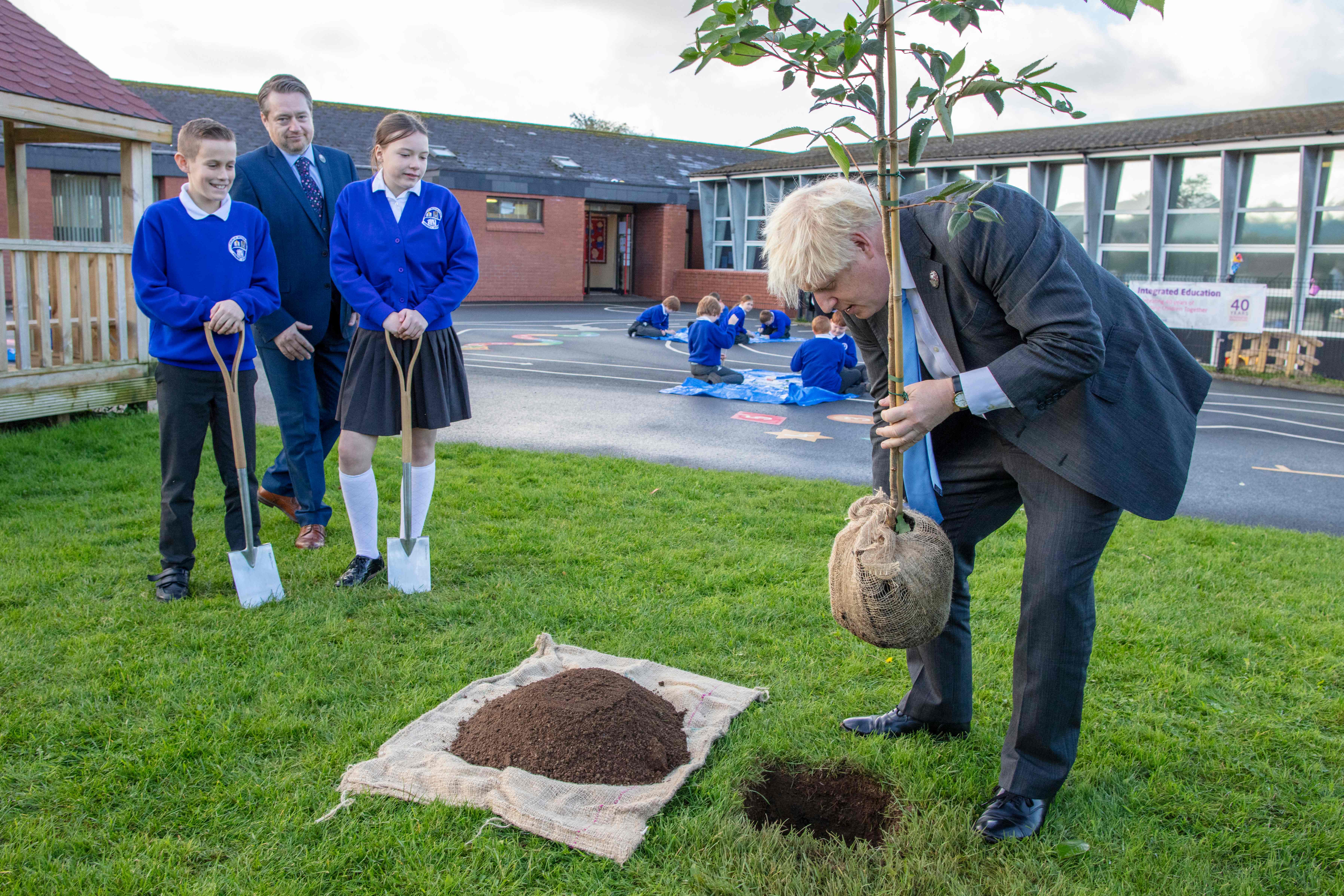 The PM planting a tree at a school in County Antrim last week
