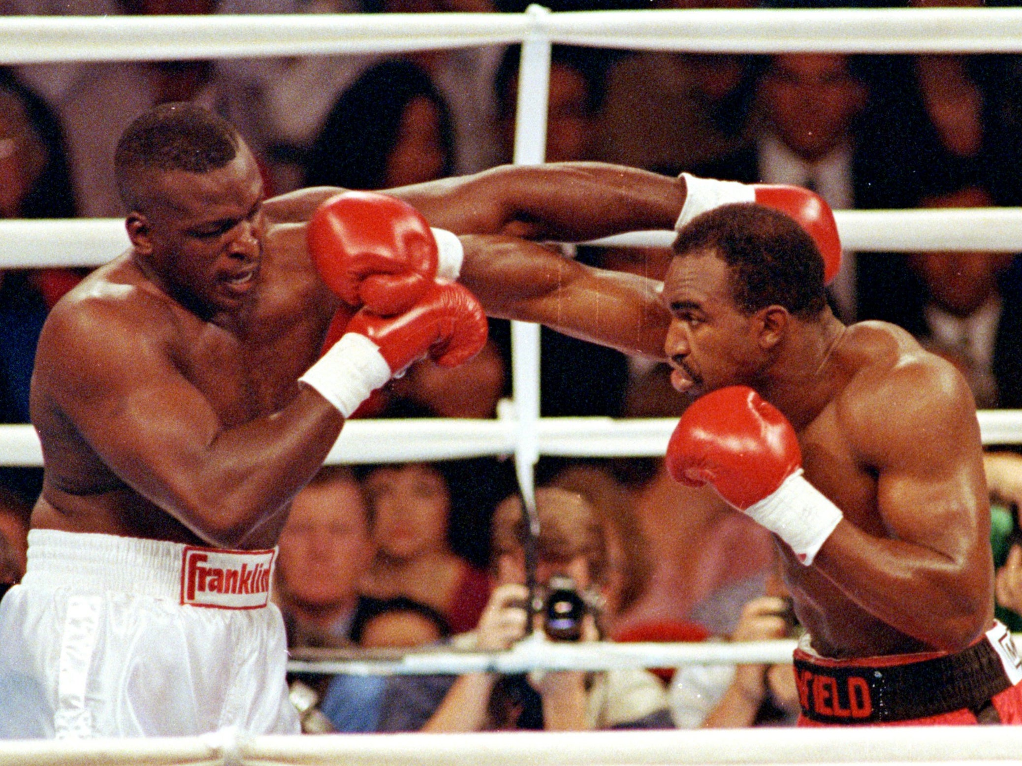 Evander Holyfield lands a right punch on James Buster Douglas