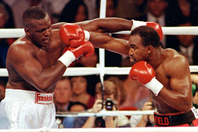 <p>Evander Holyfield lands a right punch on James Buster Douglas</p>