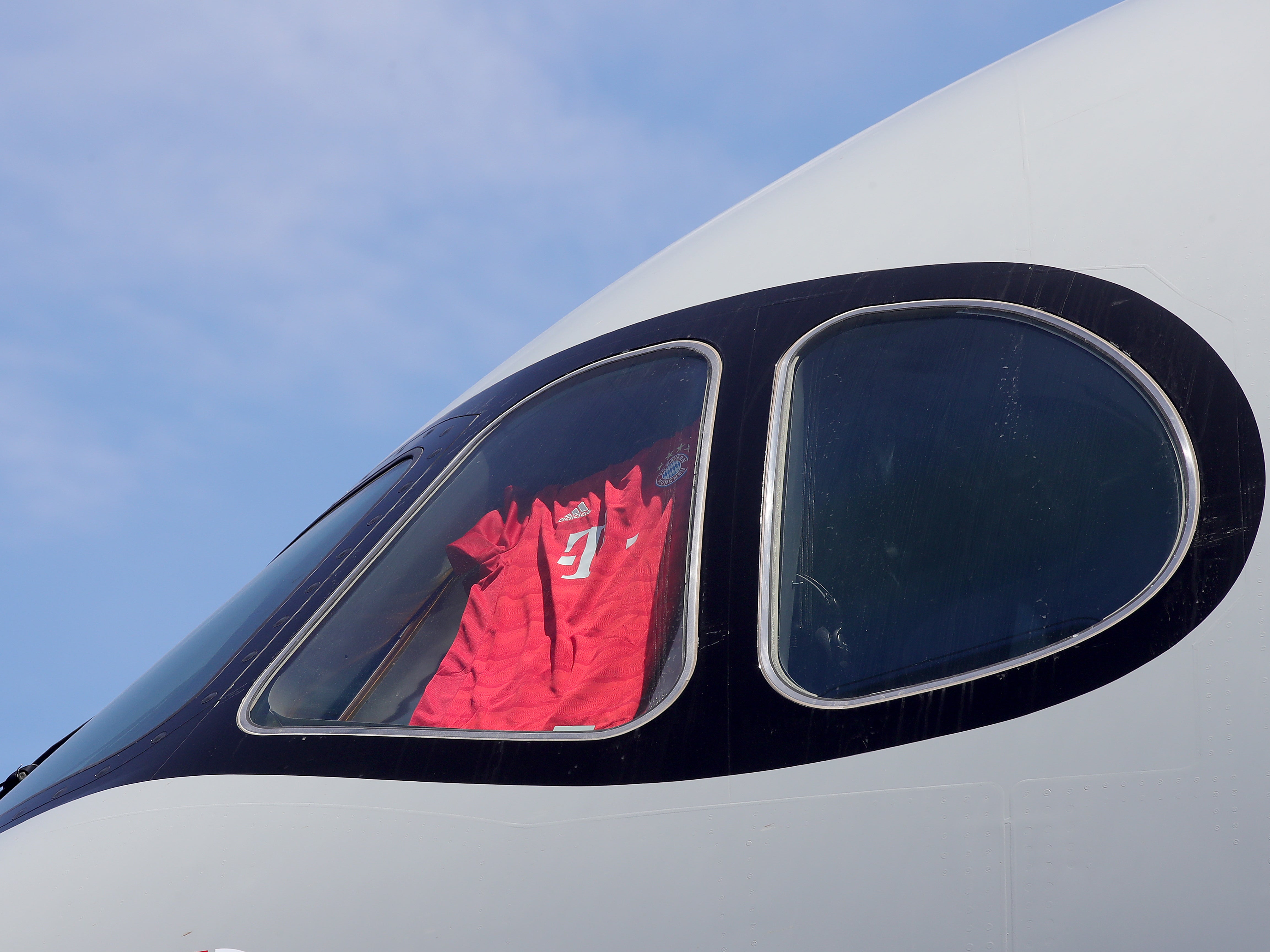 A Bayern shirt is displayed in the cockpit window of a Qatar Airways plane during a preseason tour