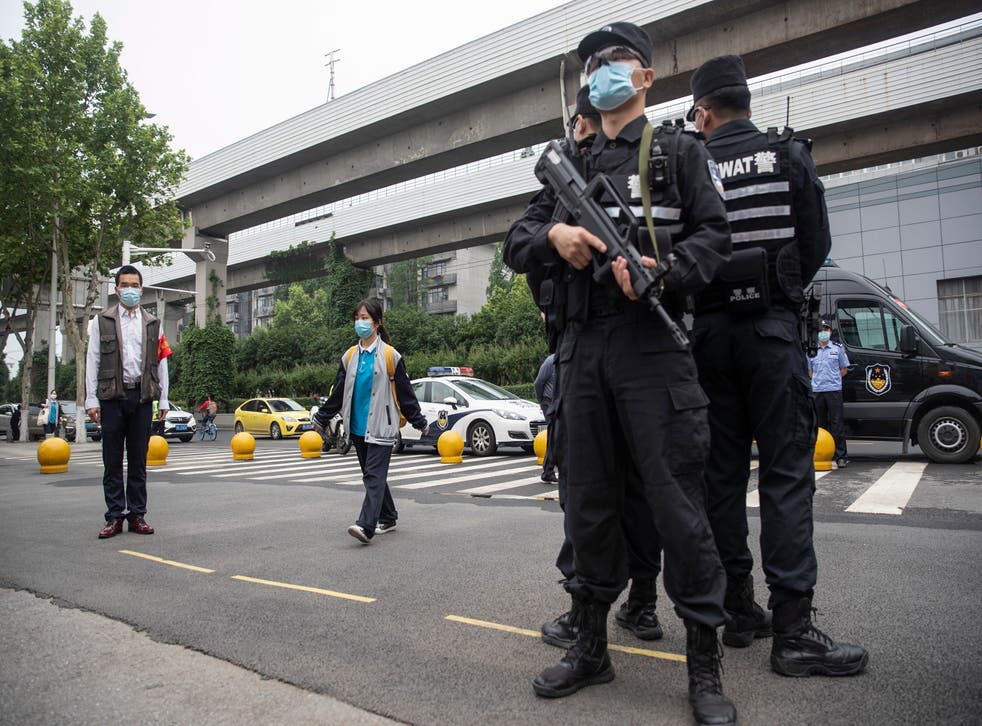 <p>File Image: Police standing outside a school in Wuhan, China on 6 May 2020</p>