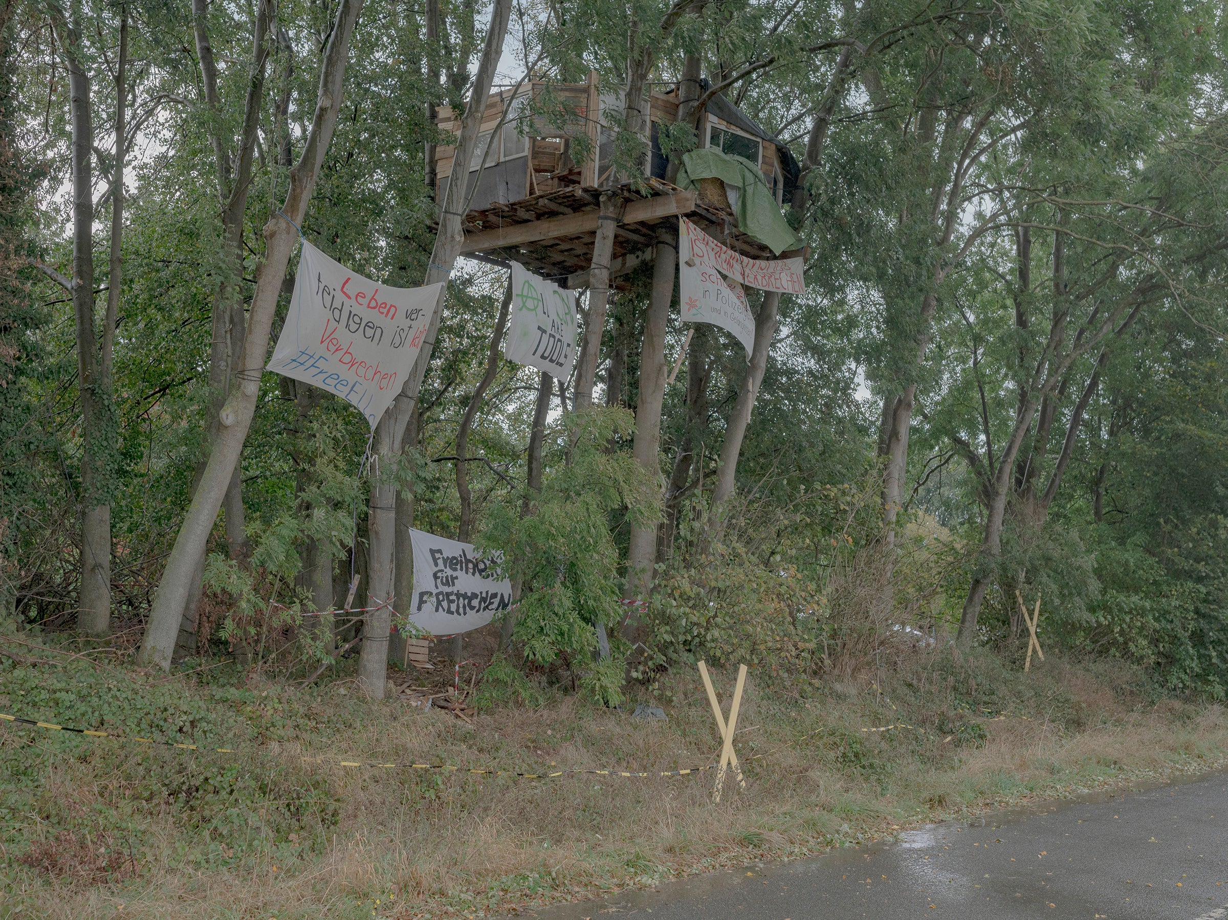 A treehouse and protest signs used by environmental activists in Luetzerath