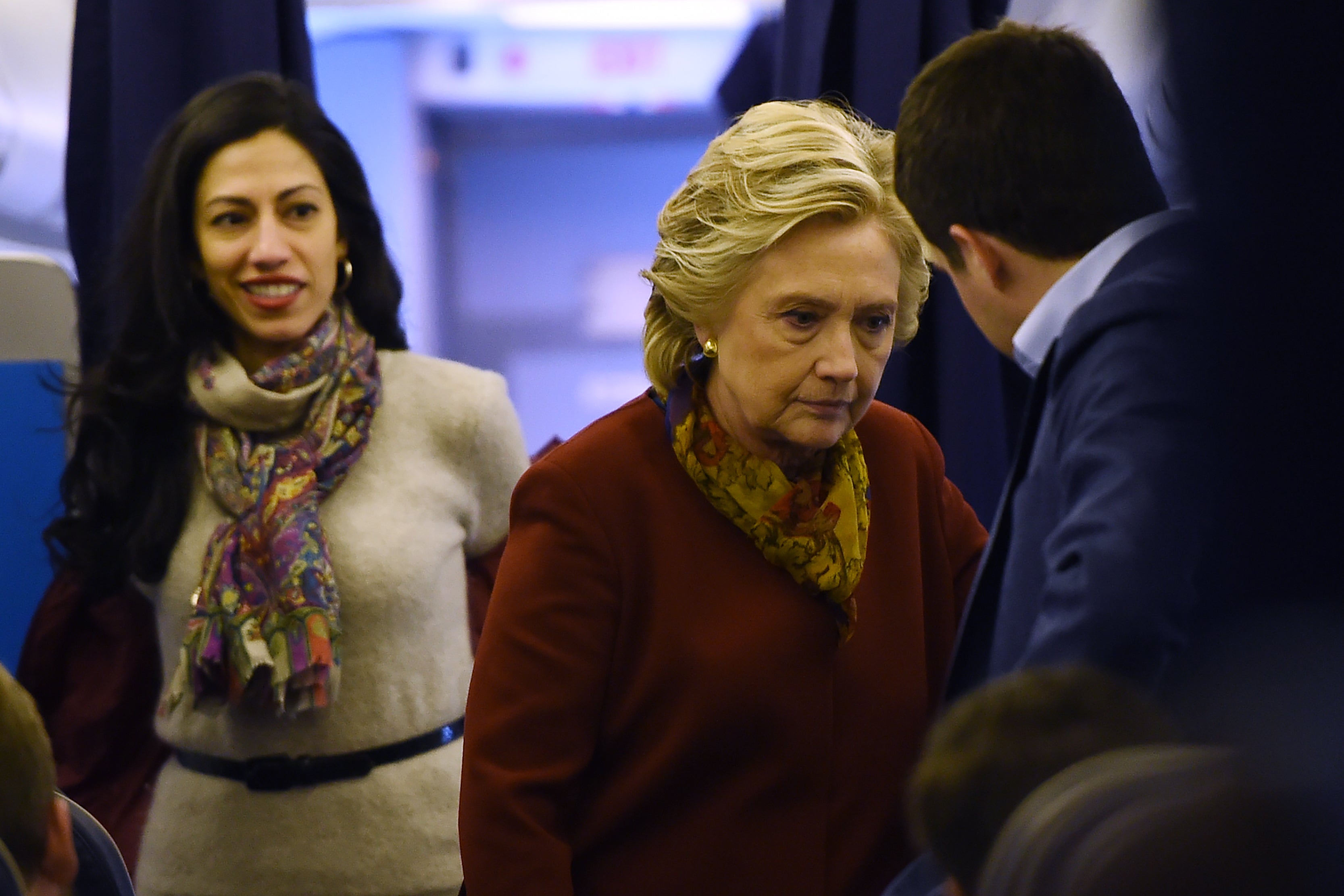 Democratic presidential nominee Hillary Clinton chats with her staff, including aide Huma Abedin (L), onboard her plane in White Plains, New York, October 22, 2016, on her way to a campaign event in Pittsburgh, Pennsylvania.