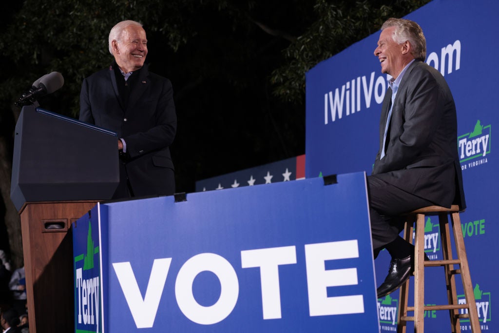 President Joe Biden shares a laugh with Virginia gubernatorial candidate Terry McAuliffe at a rally in Arlington on Tuesday