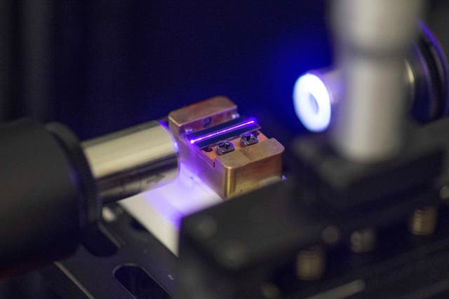 <p>A laser tests the optical waveguide of a chip for quantum computing in a lab at the technology company Q.ant in Stuttgart</p>