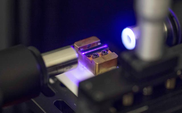 <p>A laser tests the optical waveguide of a chip for quantum computing in a laboratory at the technology company Q.ant in Stuttgart</p>