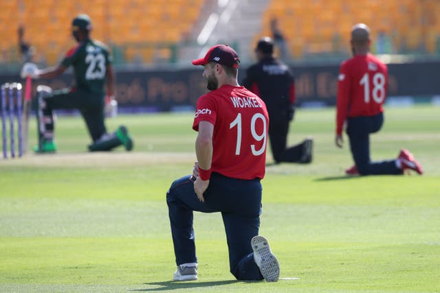 England’s Chris Woakes takes the knee ahead of the T20 World Cup game with Bangladesh (Aijaz Rahi/AP)