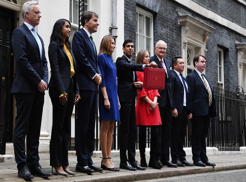 <p>Rishi Sunak and his economic staff stand outside No 11 Downing Street with his Budget box</p>