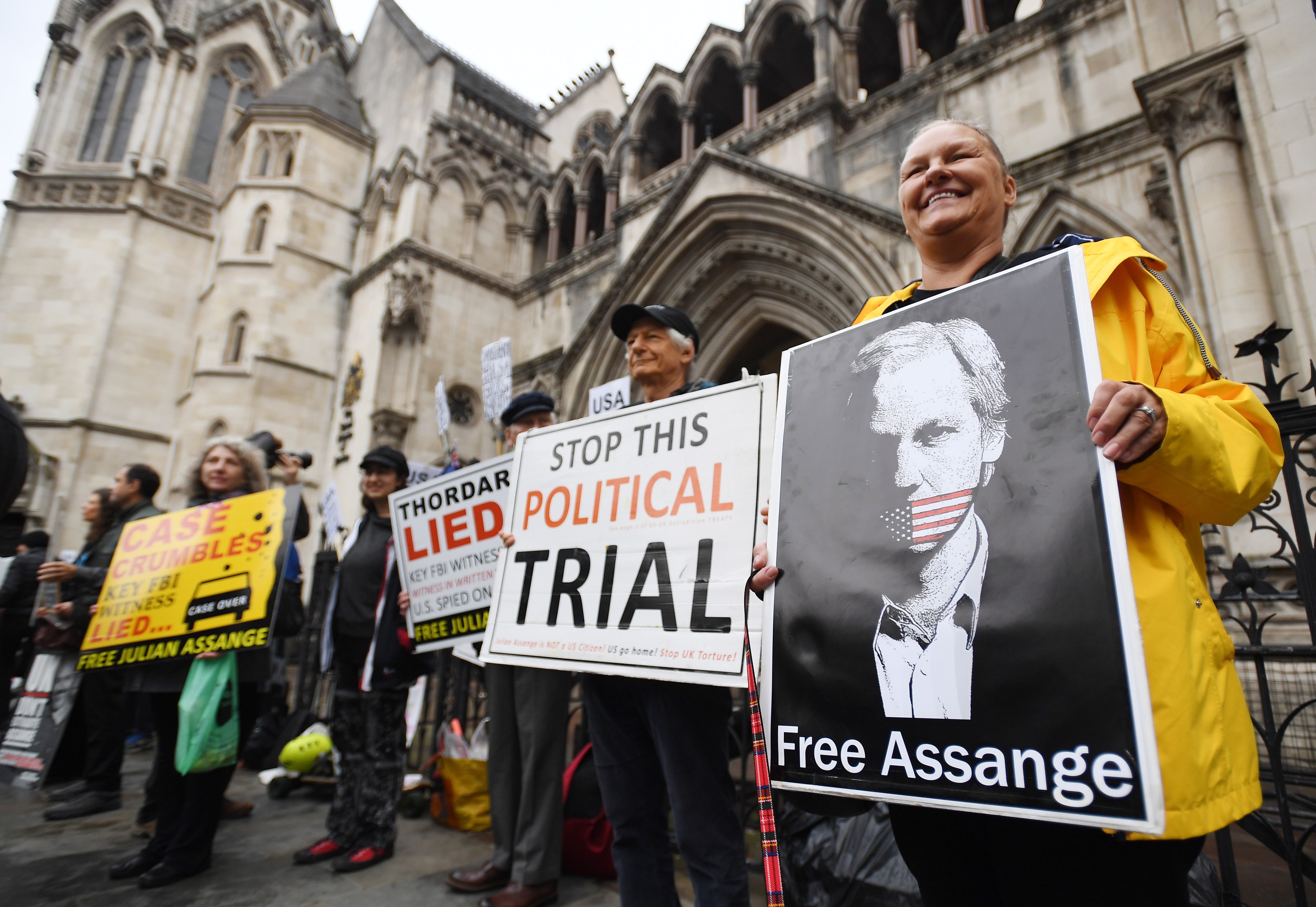 Supporters of Wikileaks founder Julian Assange demonstrate outside the Royal Courts of Justice in London