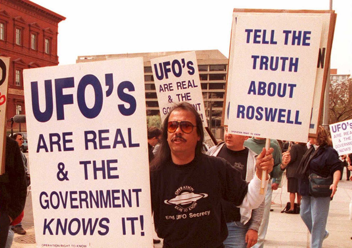 Supporters of the UFO theory march in front of the General Accounting Office