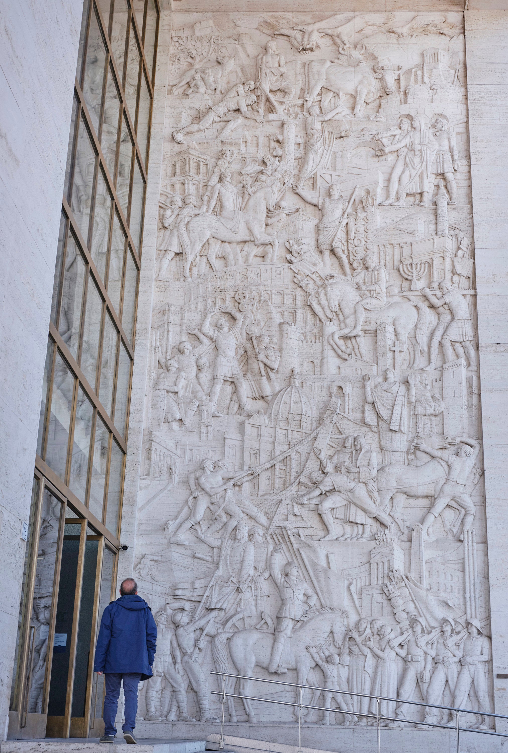 A bas-relief shows a selective history of Rome, including Mussolini on horseback