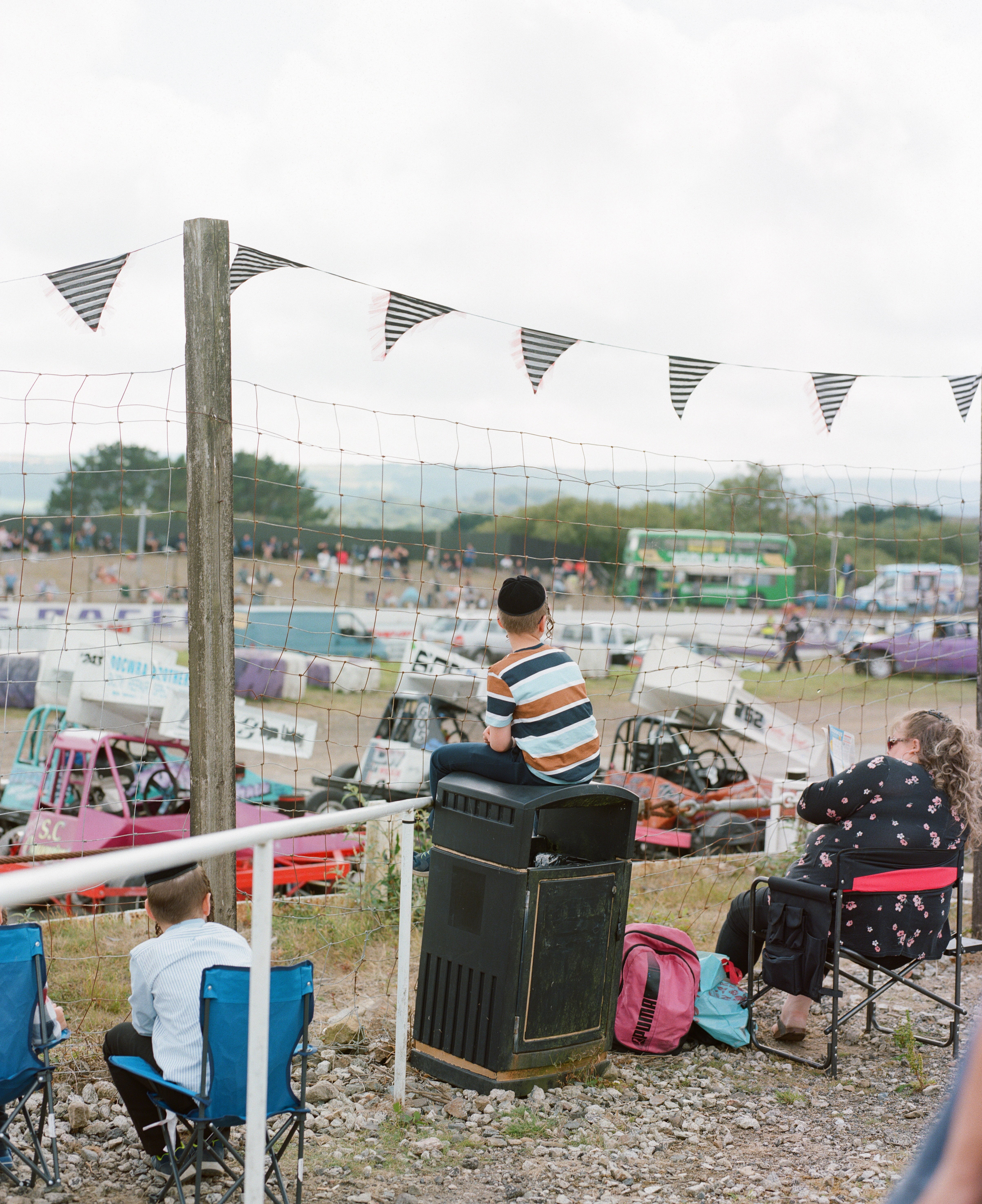 A boy catches a good view of the race atop a bin