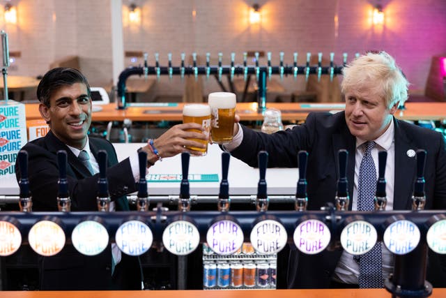 <p>Boris Johnson and Rishi Sunak visit the Fourpure Brewery in Bermondsey, south London, after the chancellor’s Budget</p>