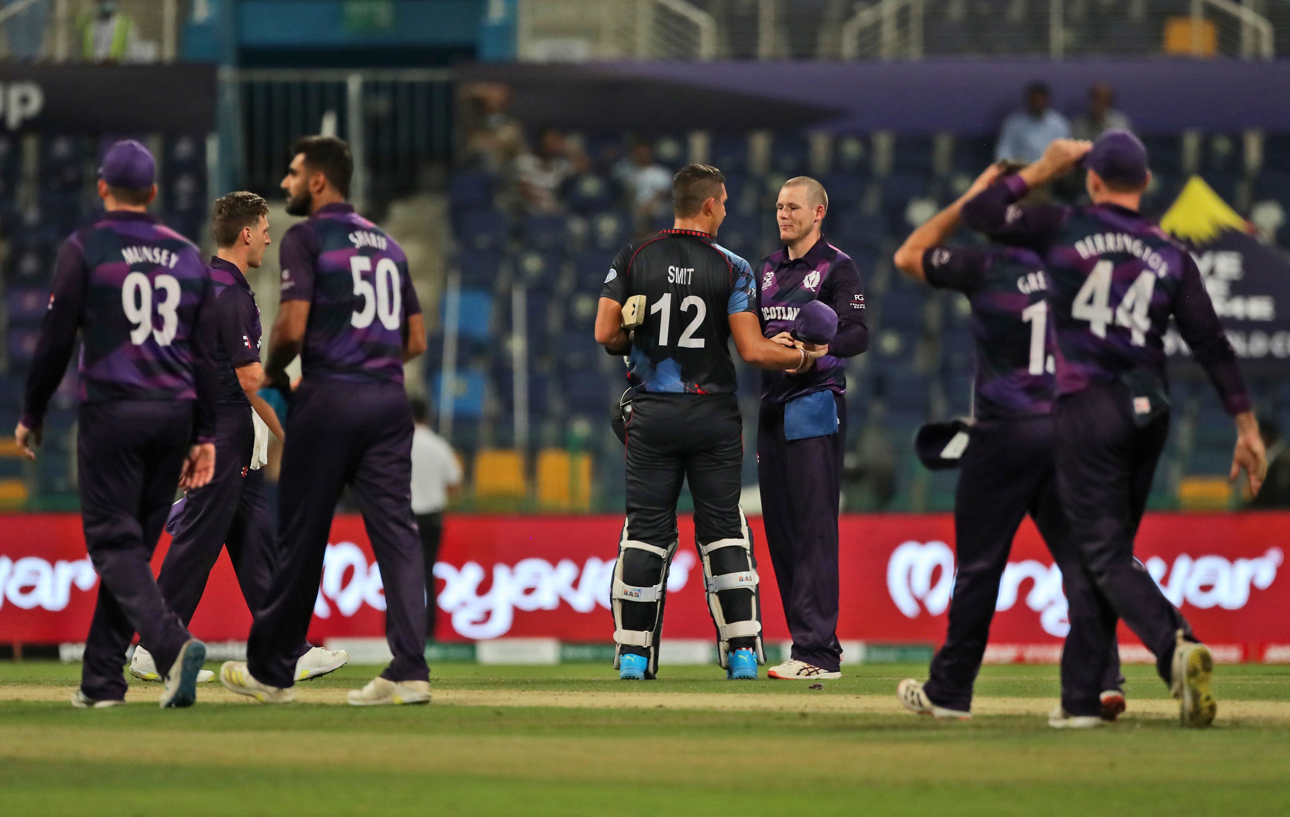 Michael Leask congratulates Namibia’s JJ Smit (AP Photo/Aijaz Rahi)