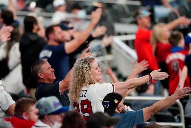 <p>Atlanta Braves fans do the ‘tomahawk chop’ during a baseball game against the Philadelphia Phillies</p>