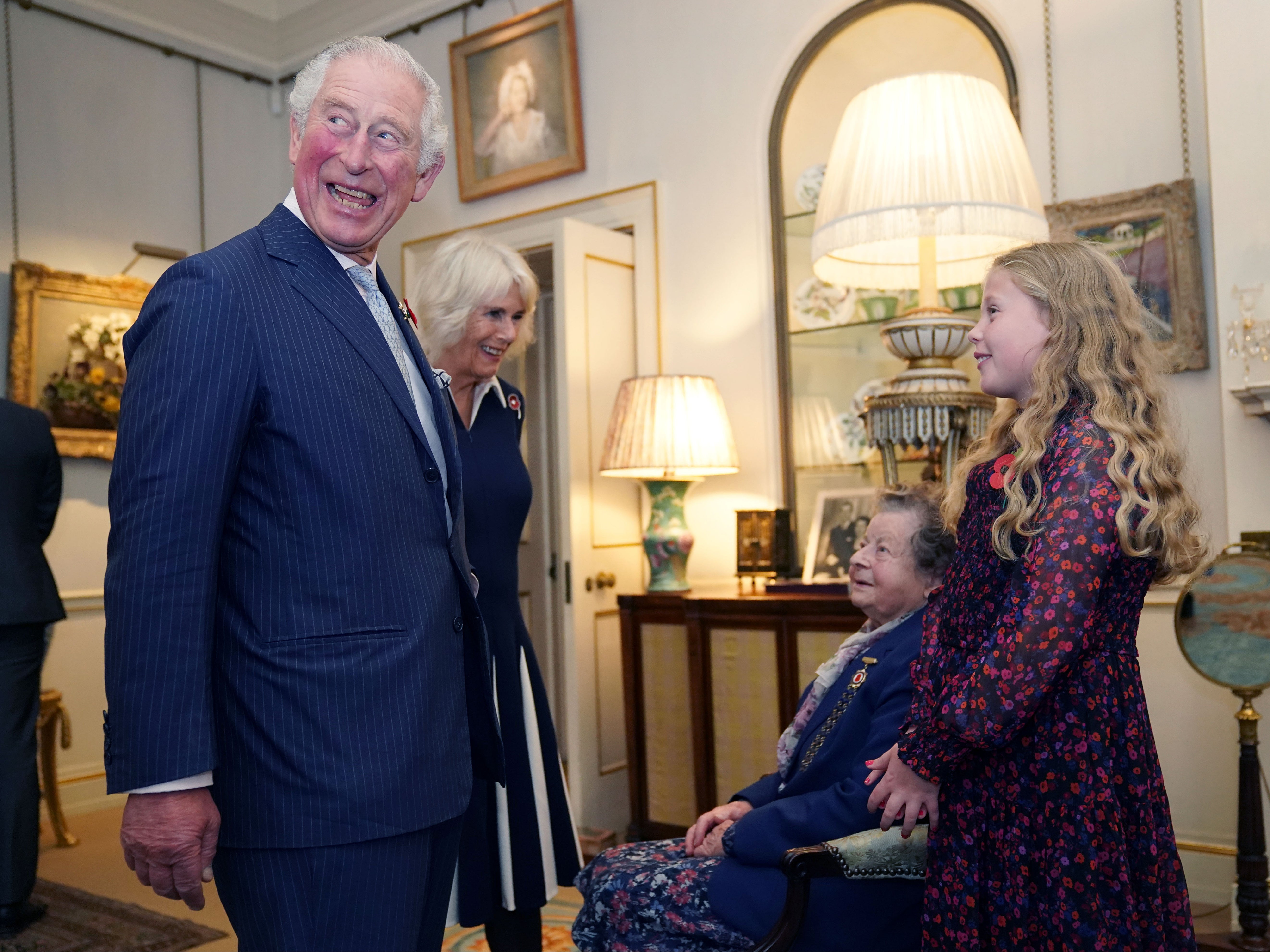 Prince Charles, Prince of Wales and Camilla, Duchess of Cornwall (second left) talk with Jill Gladwell, aged 95, and Maisie Mead, 10, who are the oldest and youngest of ten Royal British Legion (RBL) Poppy Appeal collector