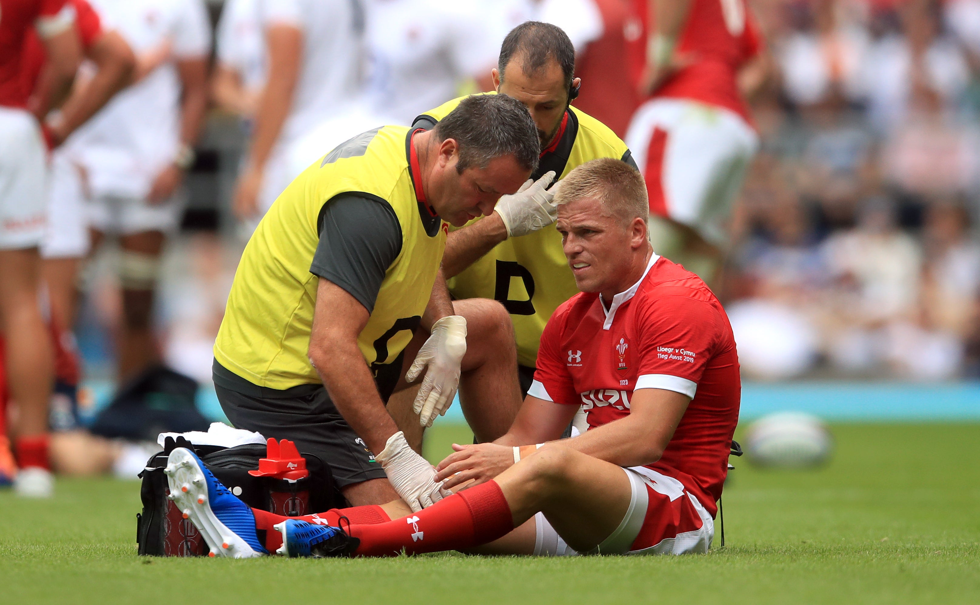 Gareth Anscombe receives treatment after being hurt in Wales’ 2019 clash against England (Adam Davy/PA)