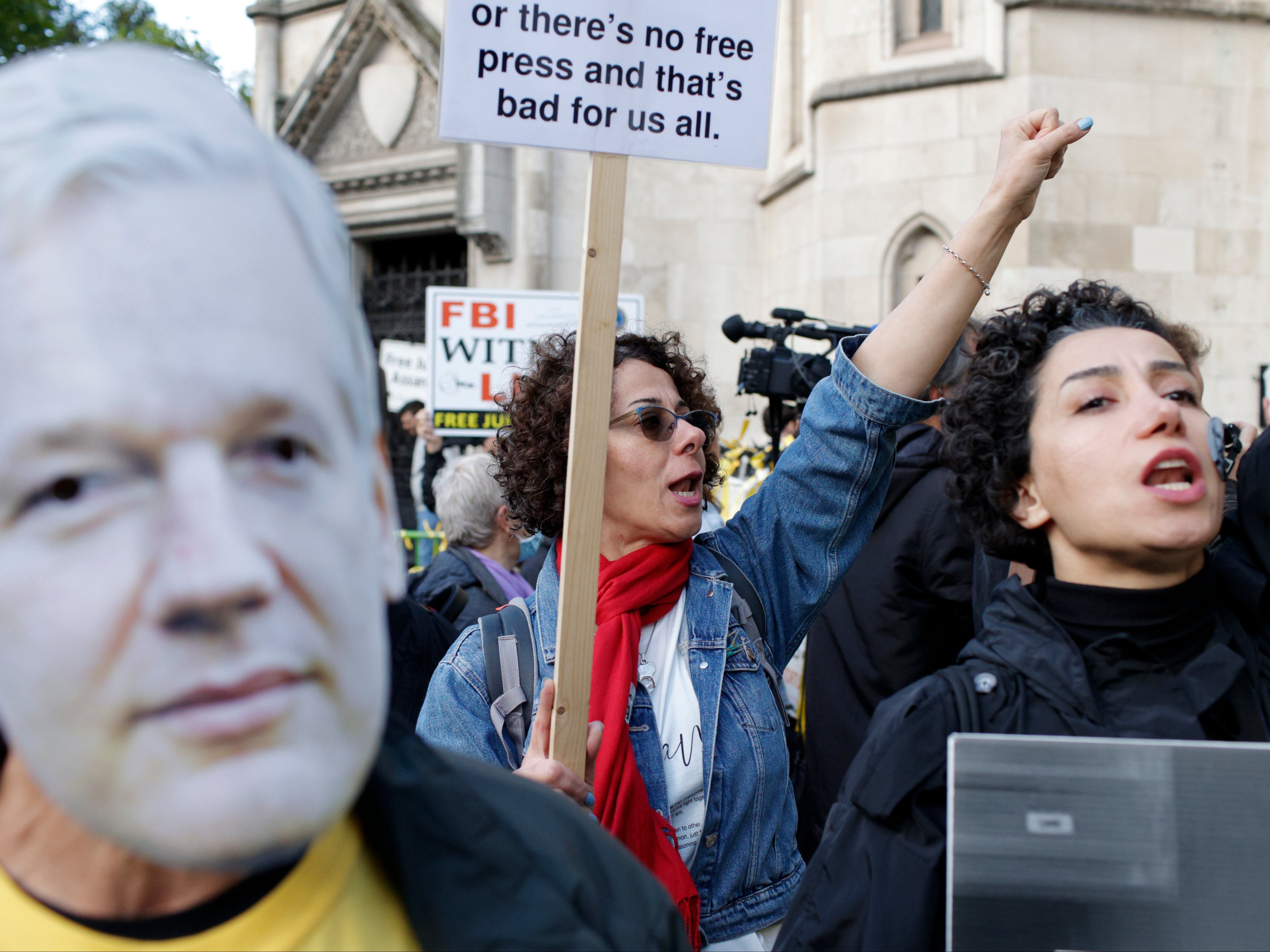 Supporters of Julian Assange demonstrate outside the High Court in London as the US government continues its bid to overturn a decision not to extradite the WikiLeaks founder