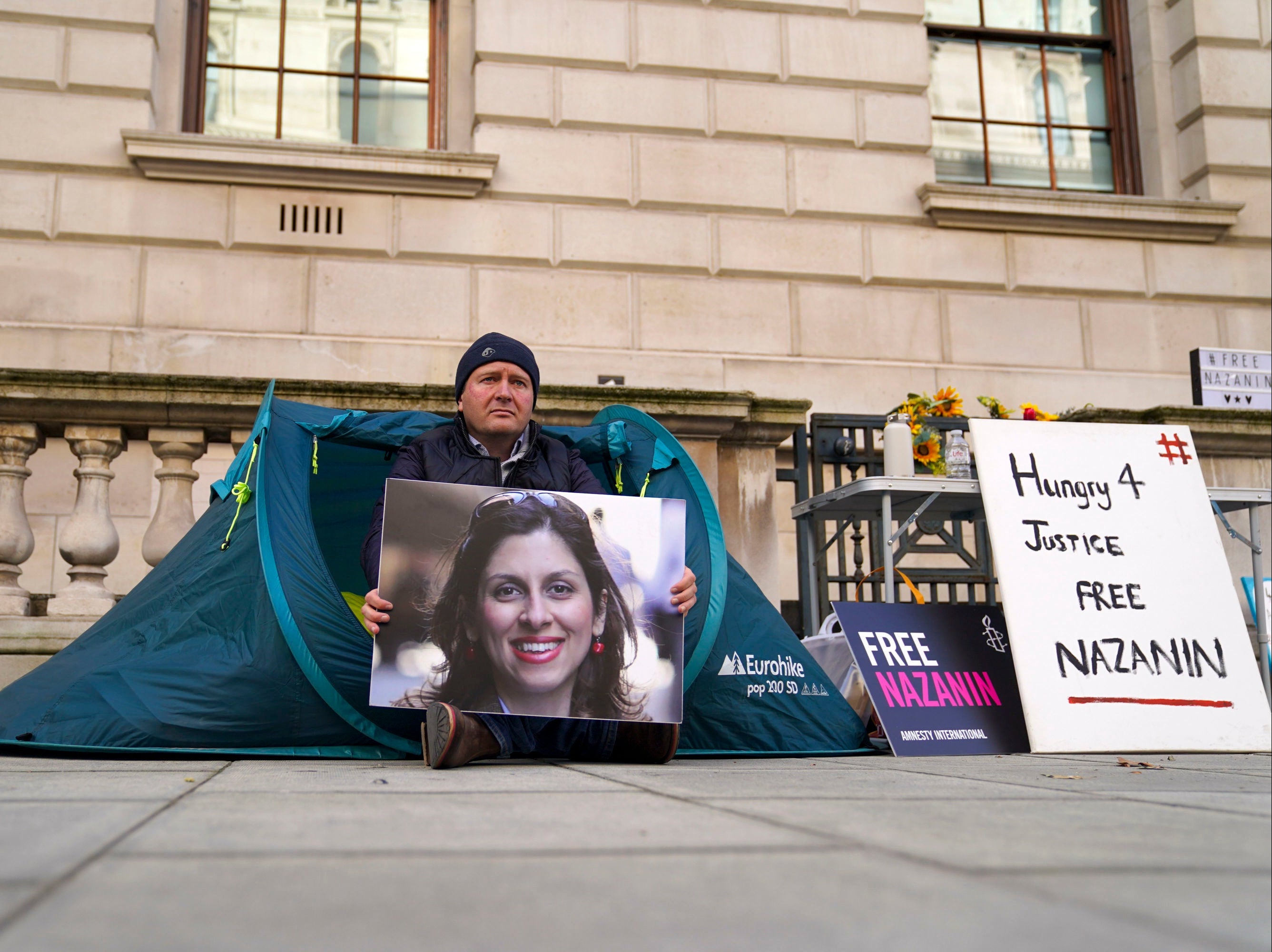 Richard Ratcliffe holds a picture of his wife Nazanin Zaghari-Ratcliffe as he continues a hunger strike outside the Foreign Office in London