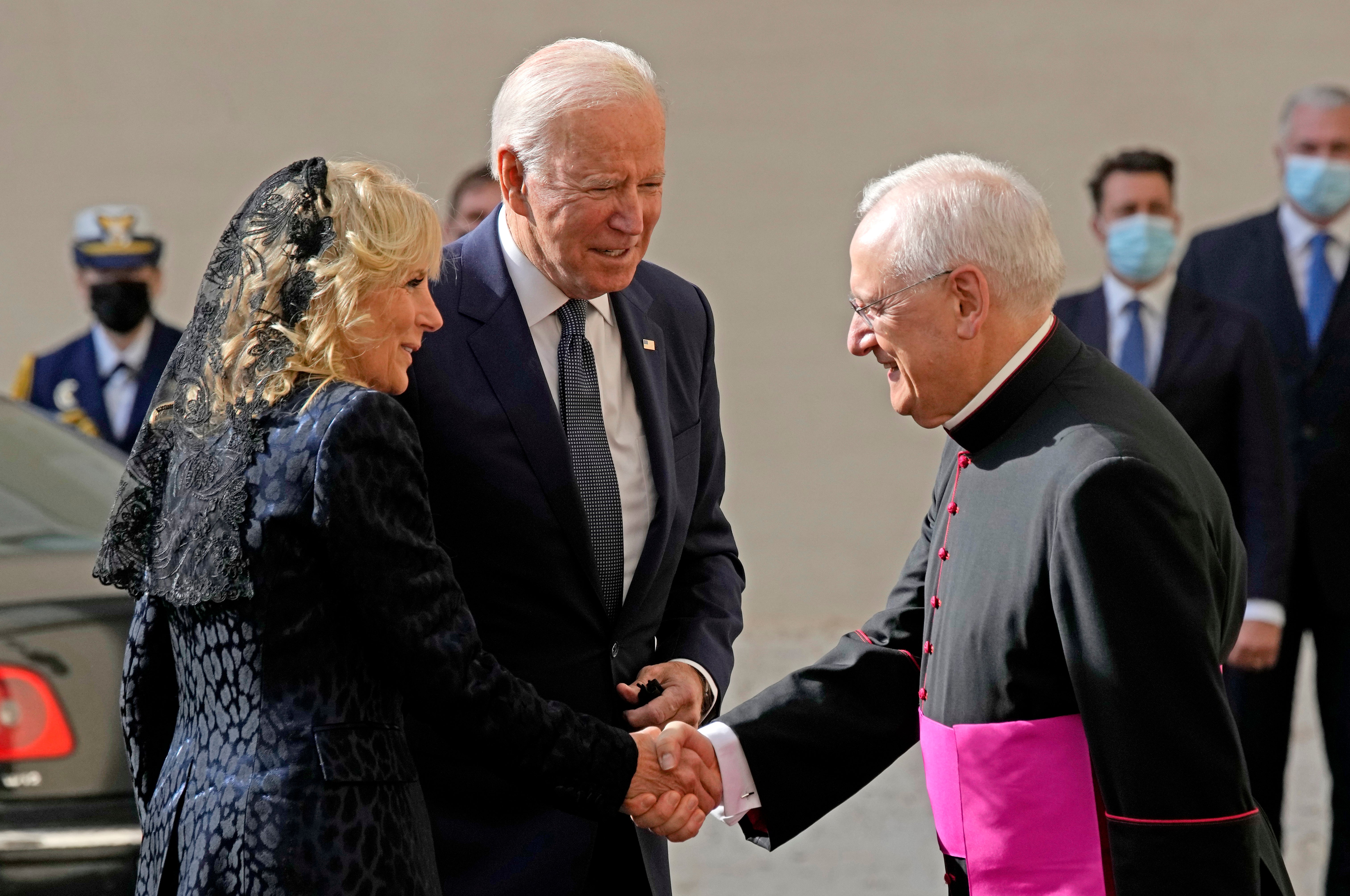 U.S. President Joe Biden and first lady Jill Biden are greeted by Head of the Papal Household, Mons. Leonardo Sapienza, right, as they arrive for a meeting with Pope Francis at the Vatican, Friday, Oct. 29, 2021.