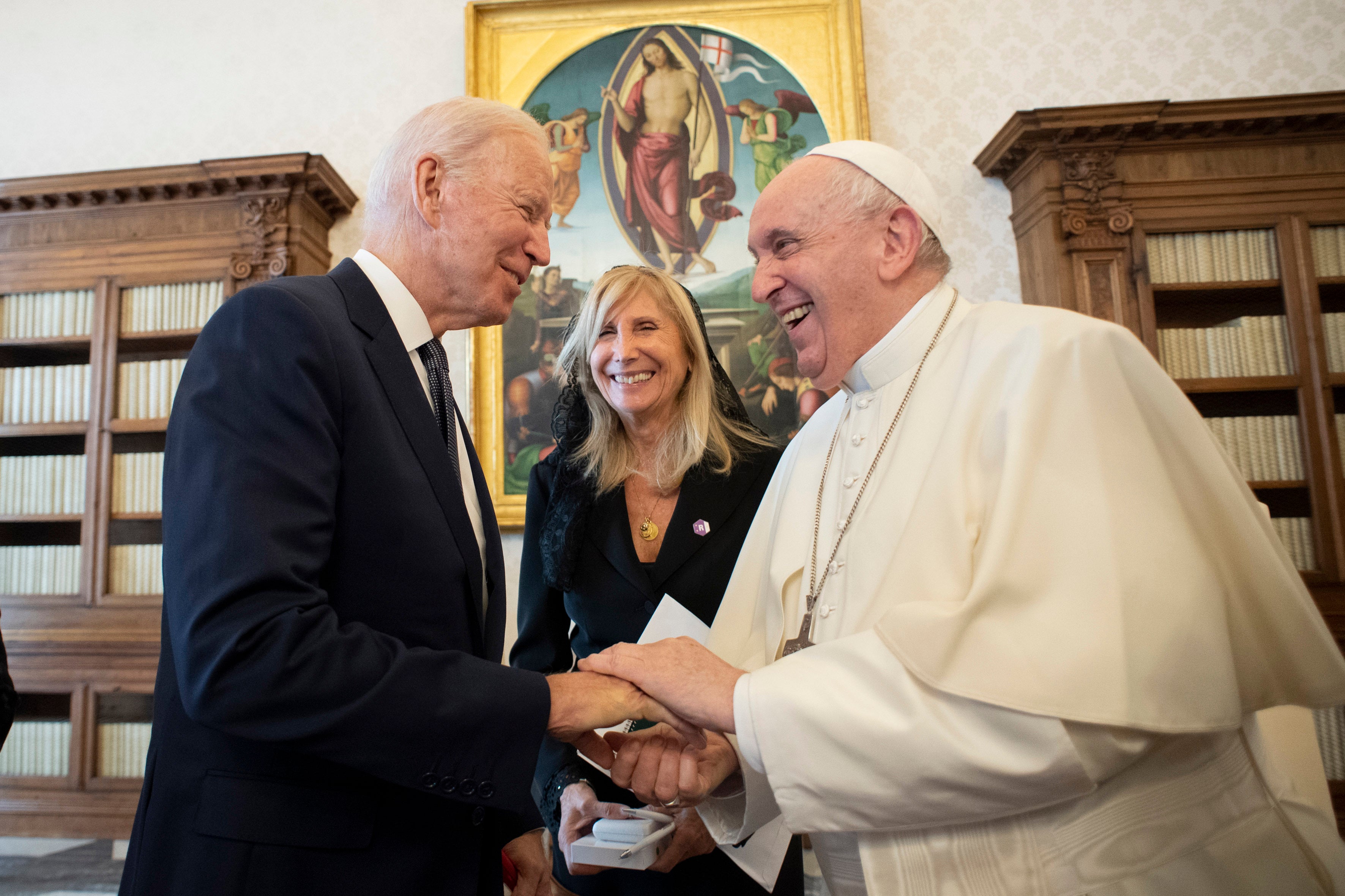 US President Joe Biden, left, shakes hands with Pope Francis as they meet at the Vatican, Friday, Oct. 29, 2021.