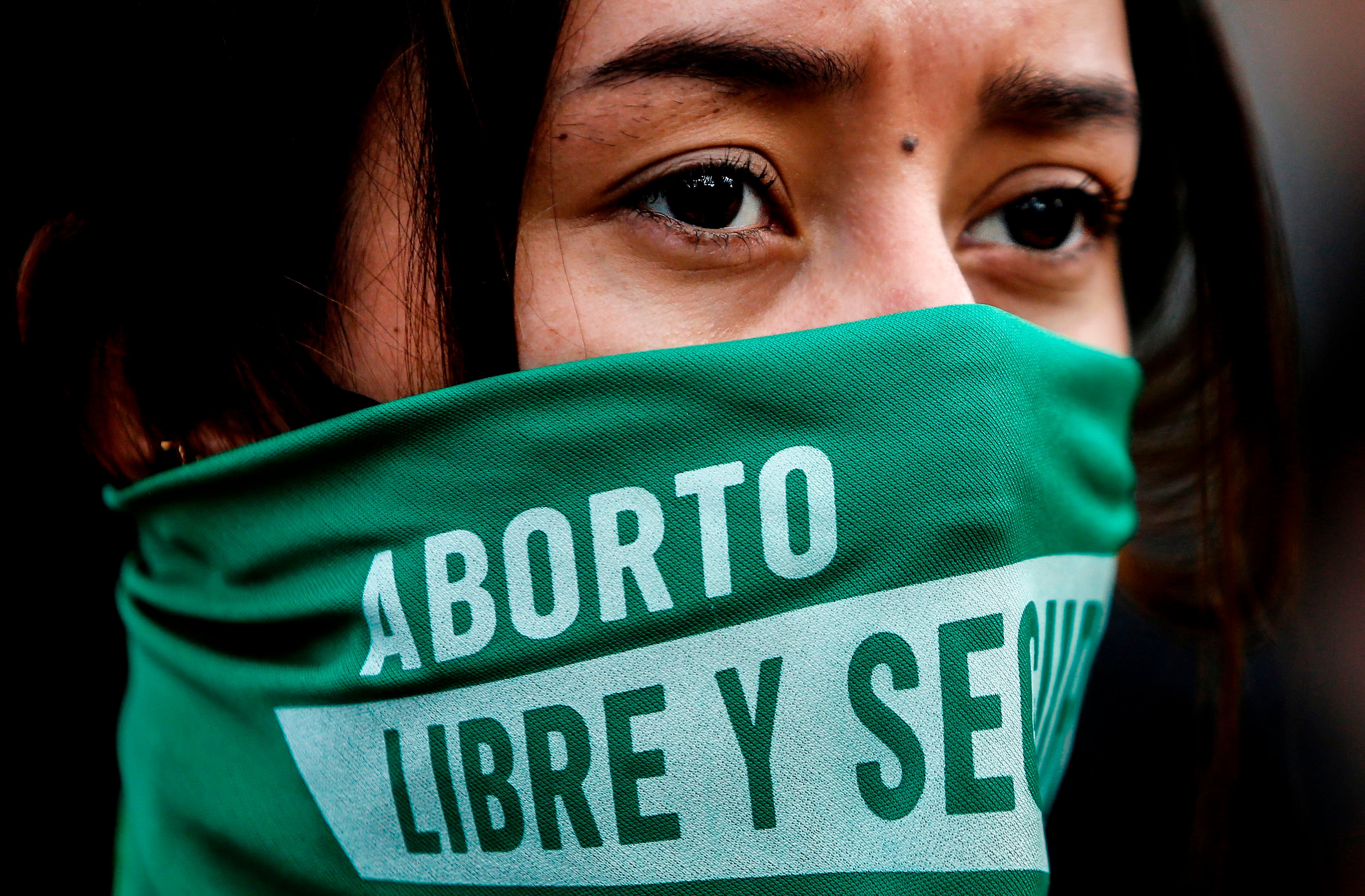 An activist wears a trademark green handkerchief at a Bogota pro-choice rally last year