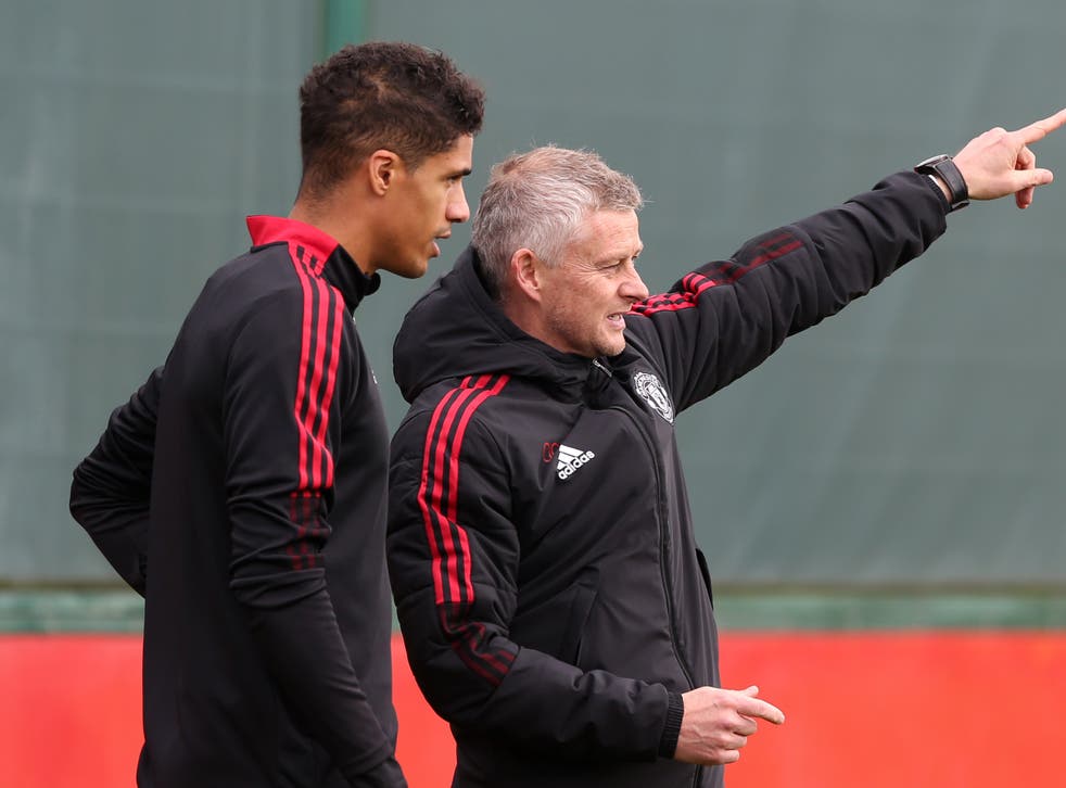 <p>Manchester United manager Ole Gunnar Solskjaer with Raphael Varane in training</p>