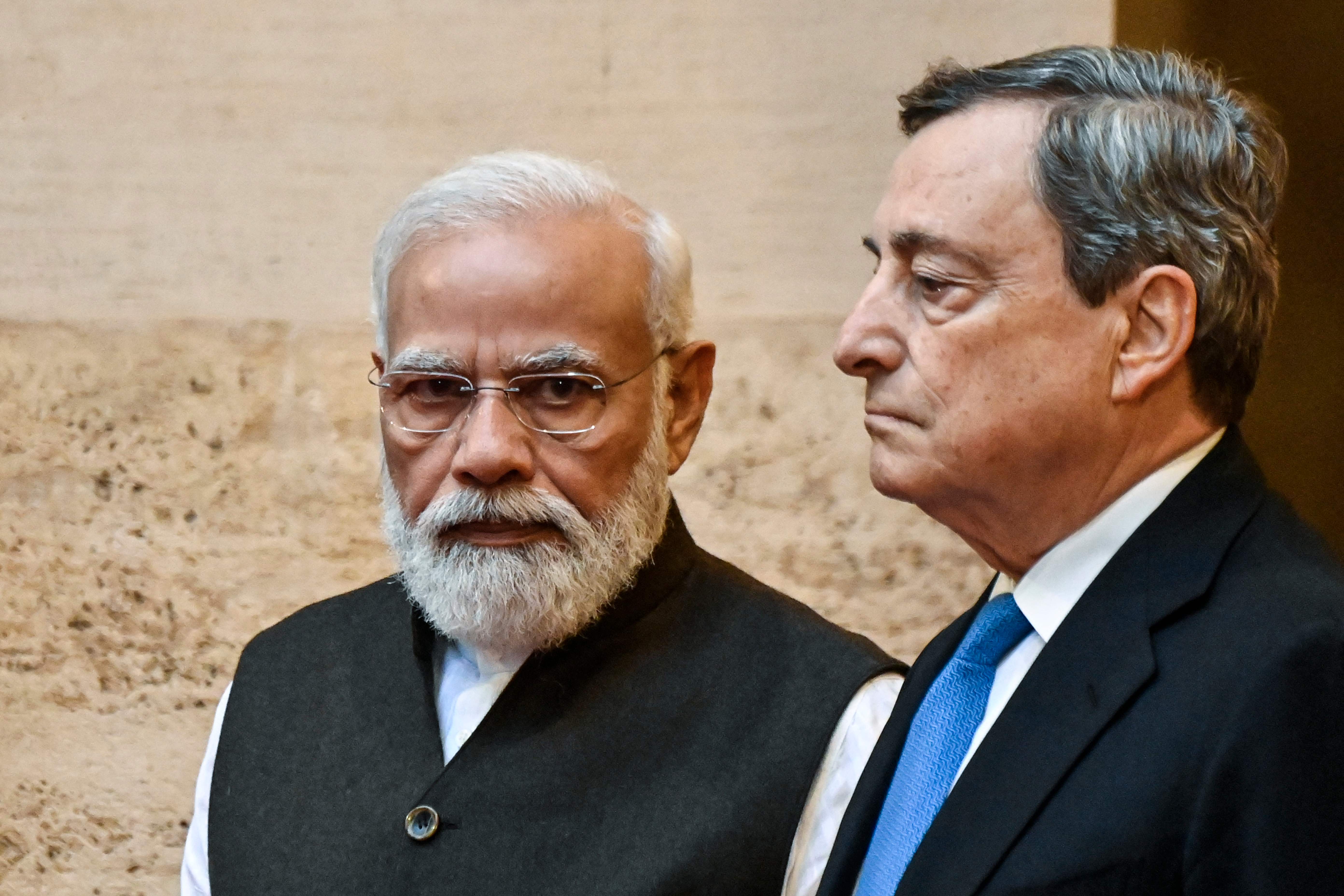 Italy’s Prime Minister, Mario Draghi (R) greets Indian Prime Minister Narendra Modi