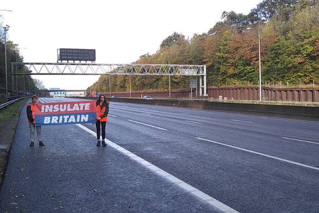 <p>Insulate Britain protesters walking along the M25 on Friday.</p>