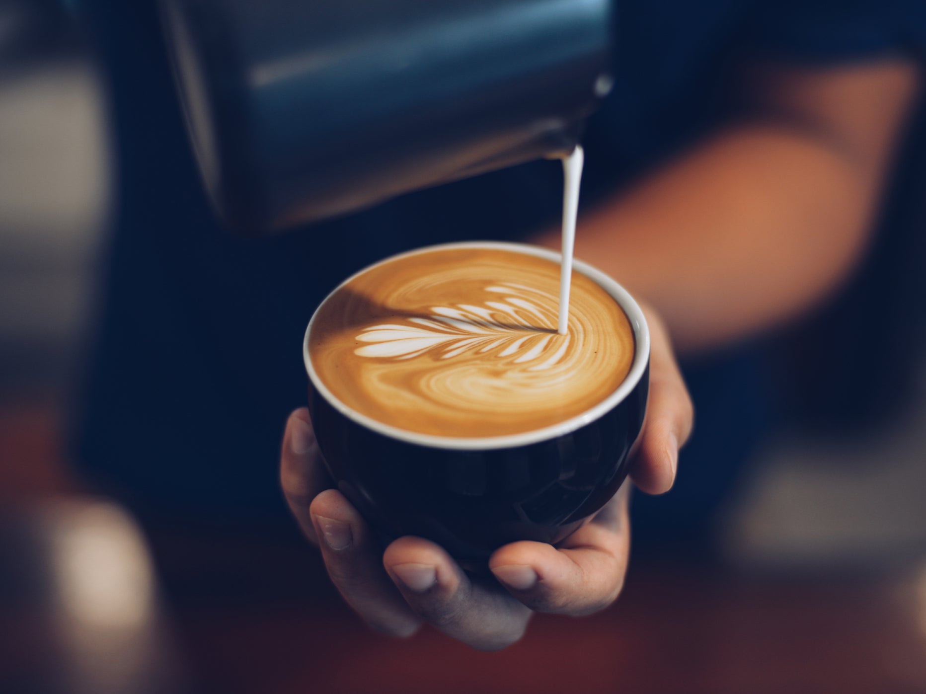 A person holds a latte
