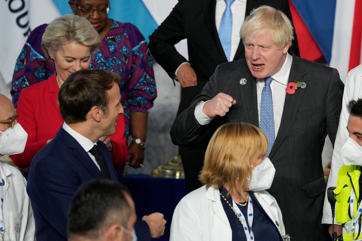Prime Minister Boris Johnson greets French President Emmanuel Macron at the G20 summit in Rome