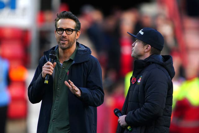 Wrexham owners Ryan Reynolds (left) and Rob McElhenney (right) speak to the crowd before the 1-1 Vanarama National League match with Torquay (Peter Byrne/PA)