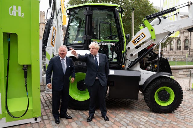 <p>Boris Johnson and JCB chair Lord Bamford at the unveiling of a hydrogen powered JCB Loadall telescopic handler </p>