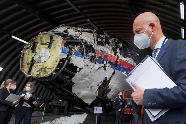 <p>Dutch judge Hendrik Steenhuis views the reconstructed wreckage of Malaysia Airlines Flight MH17 at the Gilze-Rijen military airbase   (AFP/Getty)</p>
