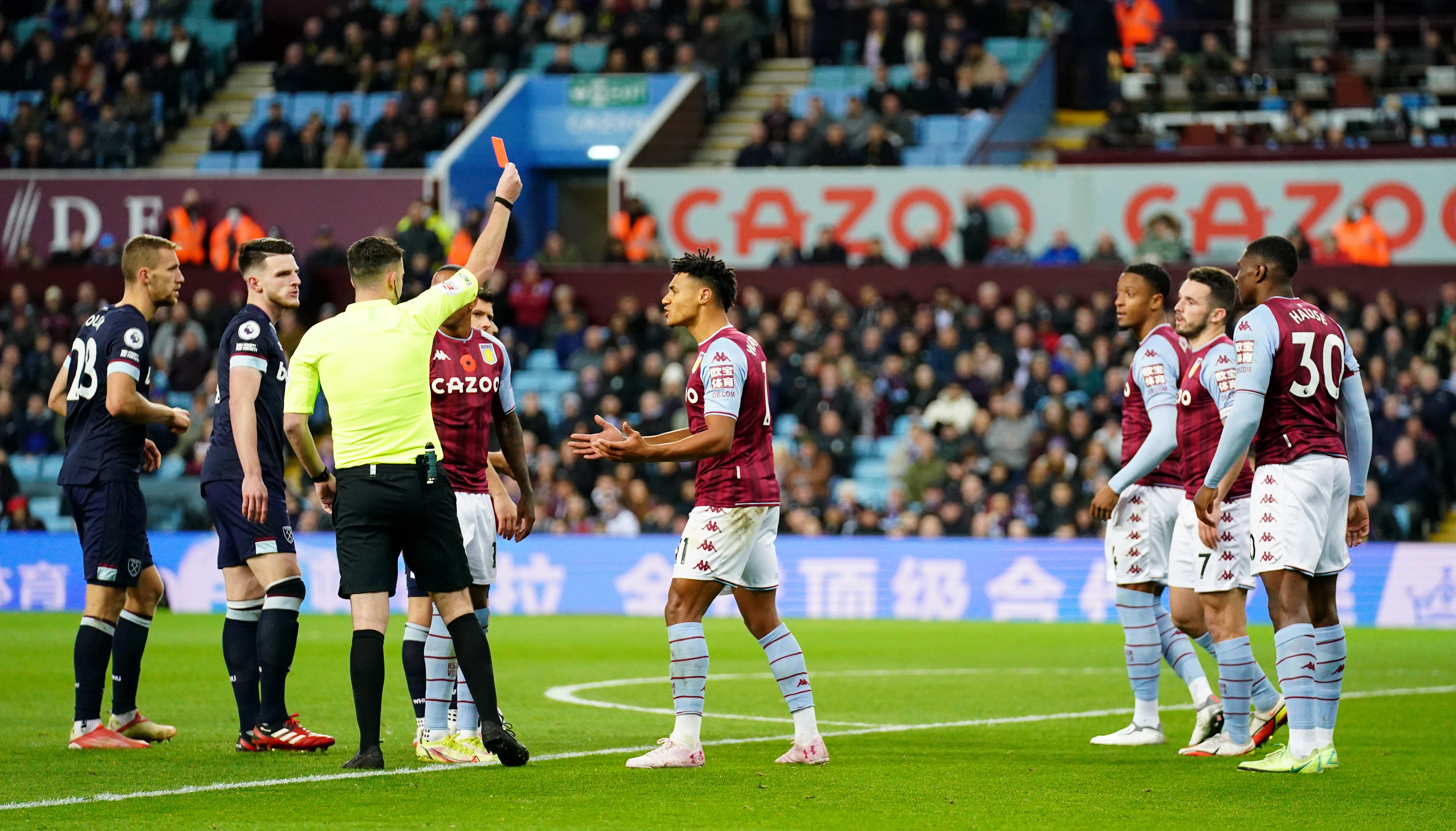 Ezri Konsa, third right, is sent off by referee Chris Kavanagh (Nick Potts/PA)