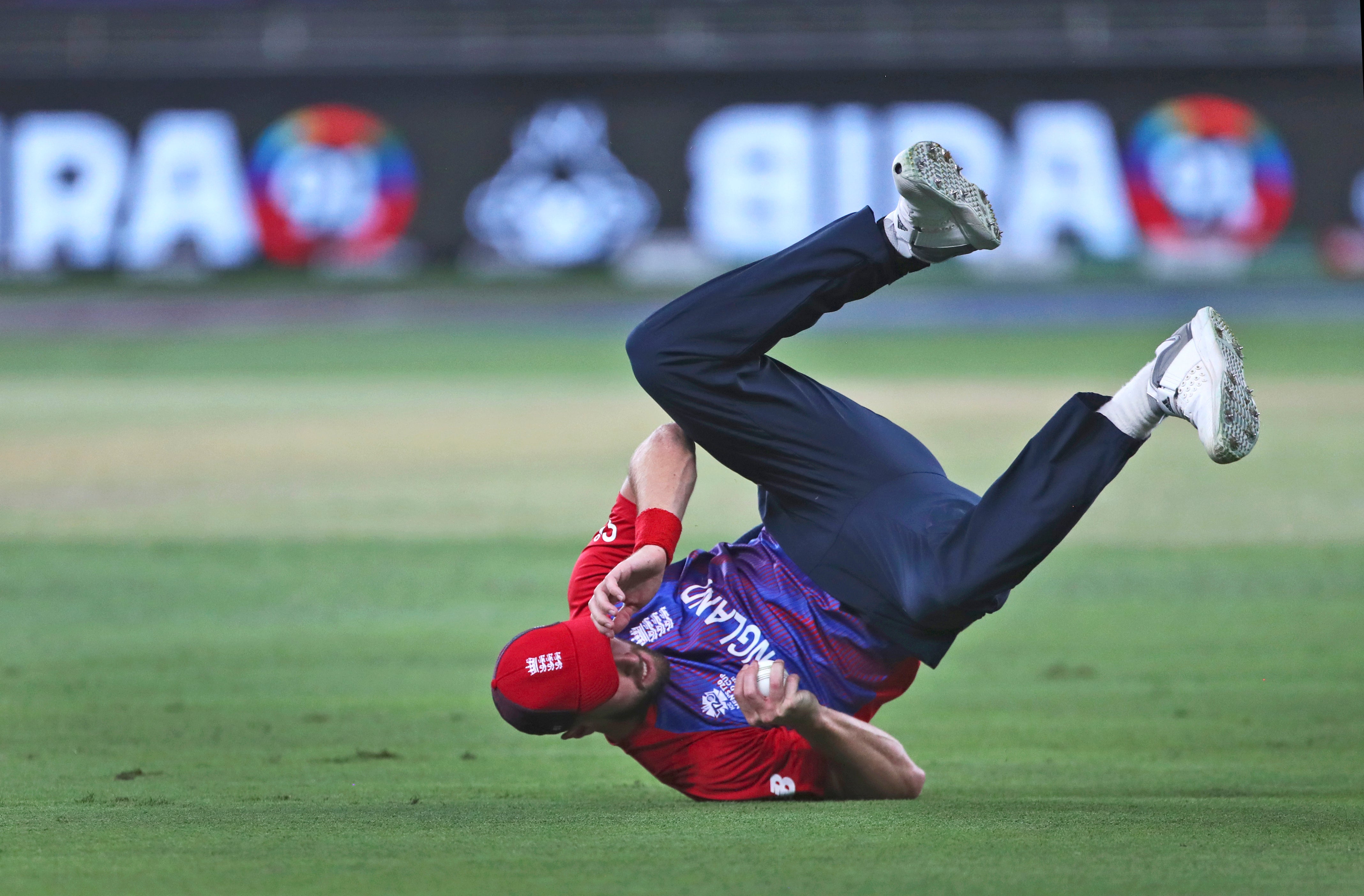 England’s Chris Woakes dives to take the catch to dismiss Australia’s Steve Smith (Aijaz Rahi/AP)