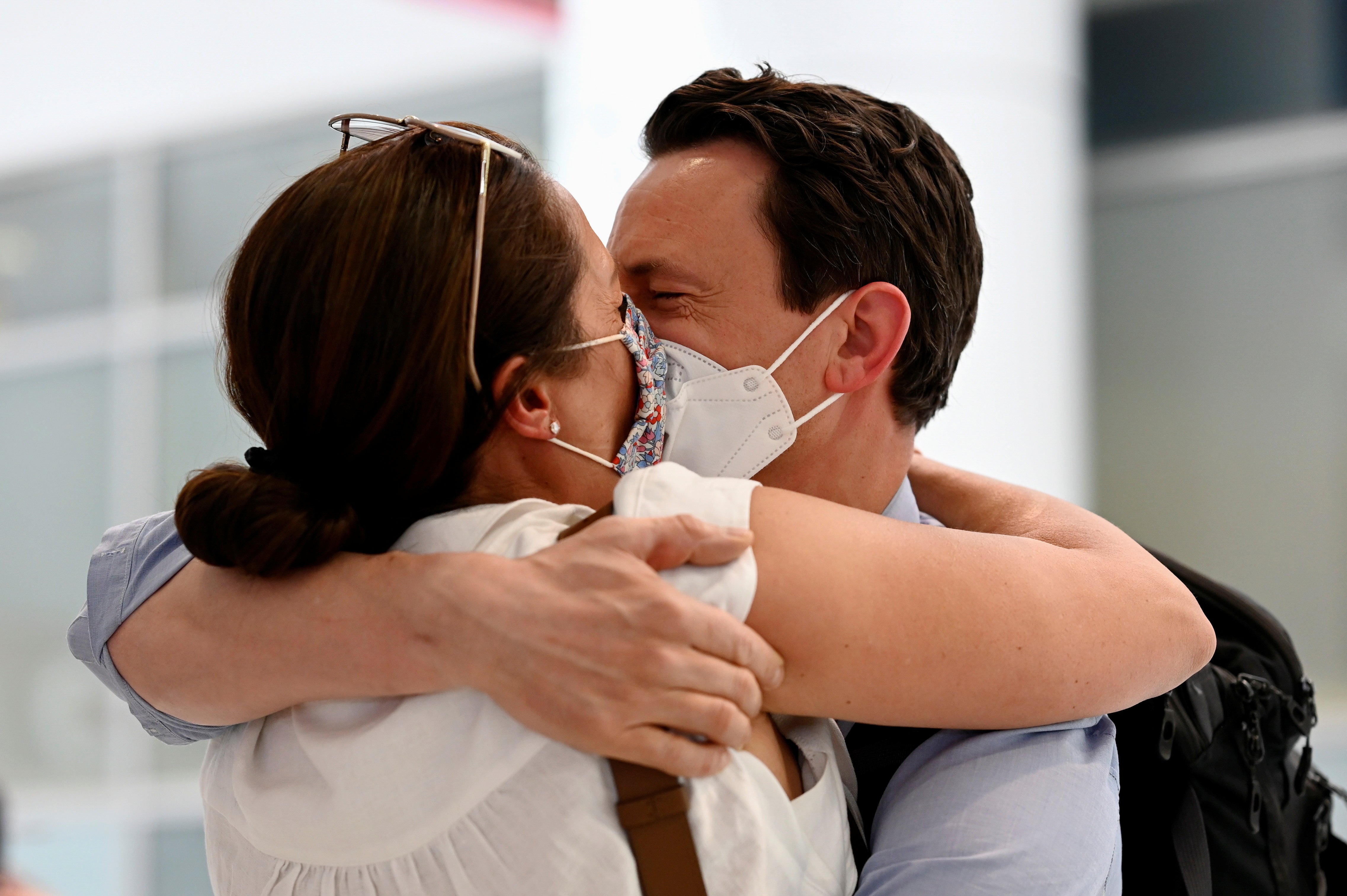 A couple, Matthew and Anthea Whitehead, are reunited at Sydney Airport