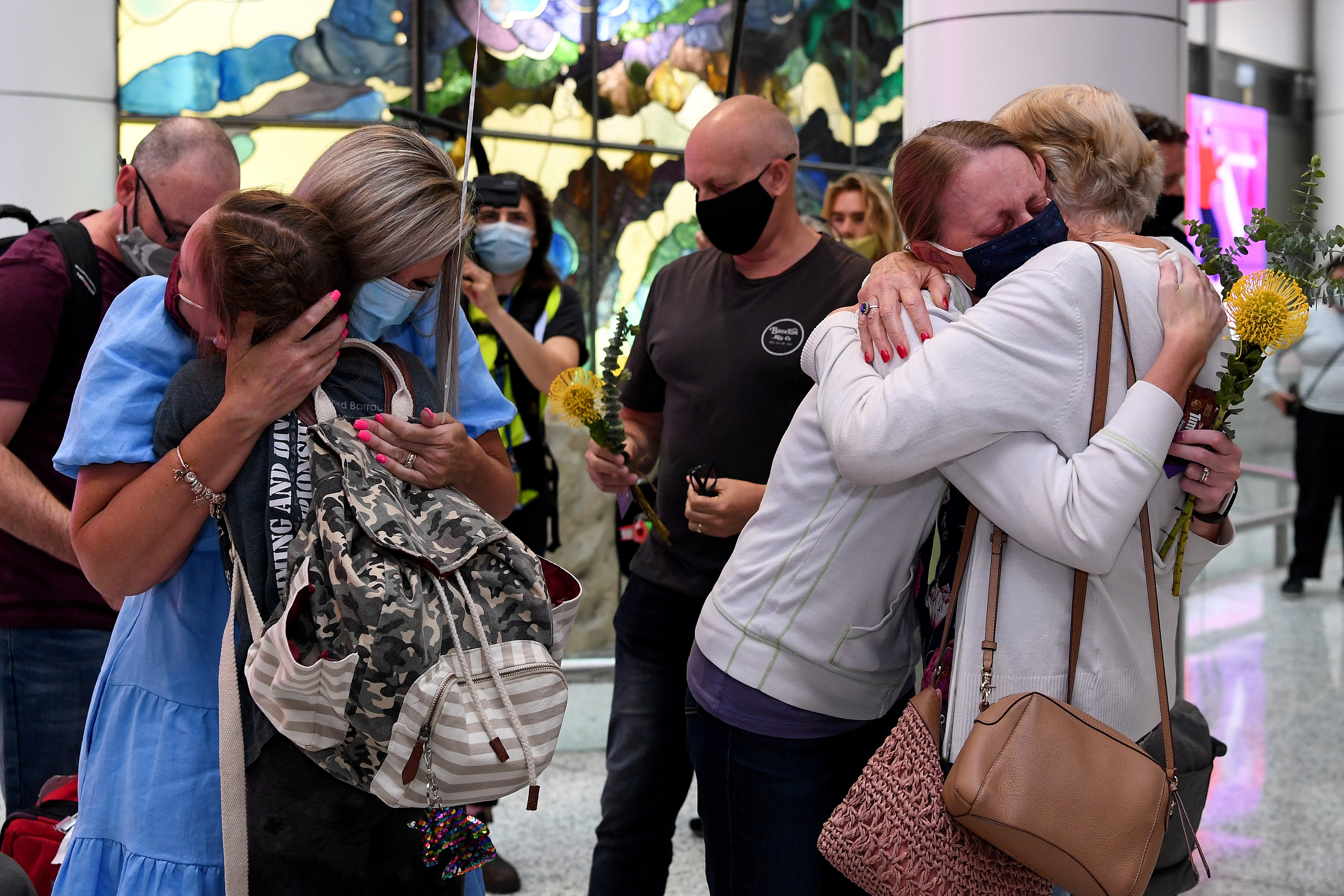 Tearful reunions at Sydney airport on Monday morning