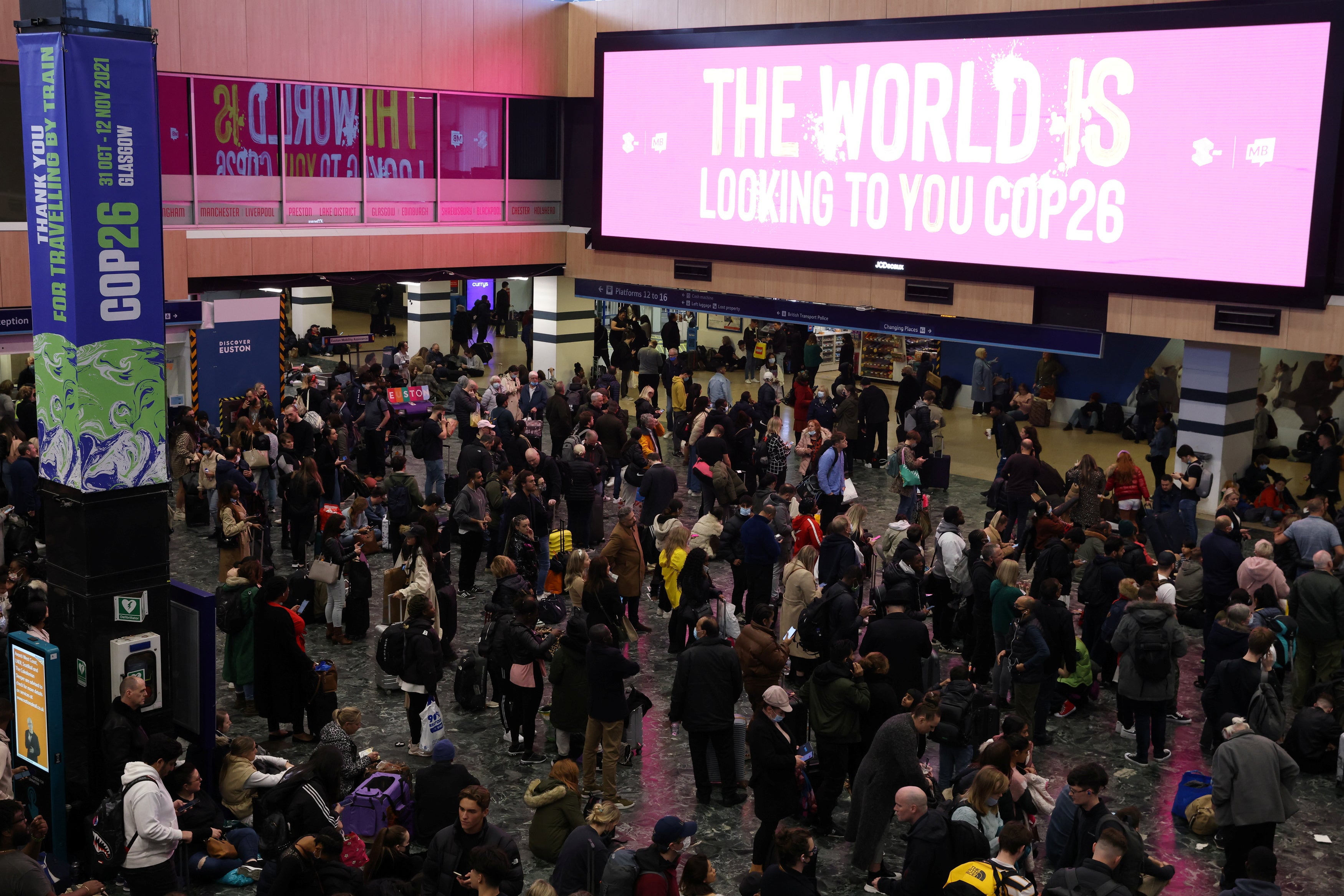 Passengers wait in Euston Station after trains were cancelled ahead of the UN Climate Change Conference (COP26)